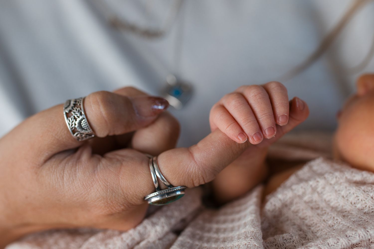 Close-up view of newborn holding moms finger  studio newborn photography Caldwell Idaho
