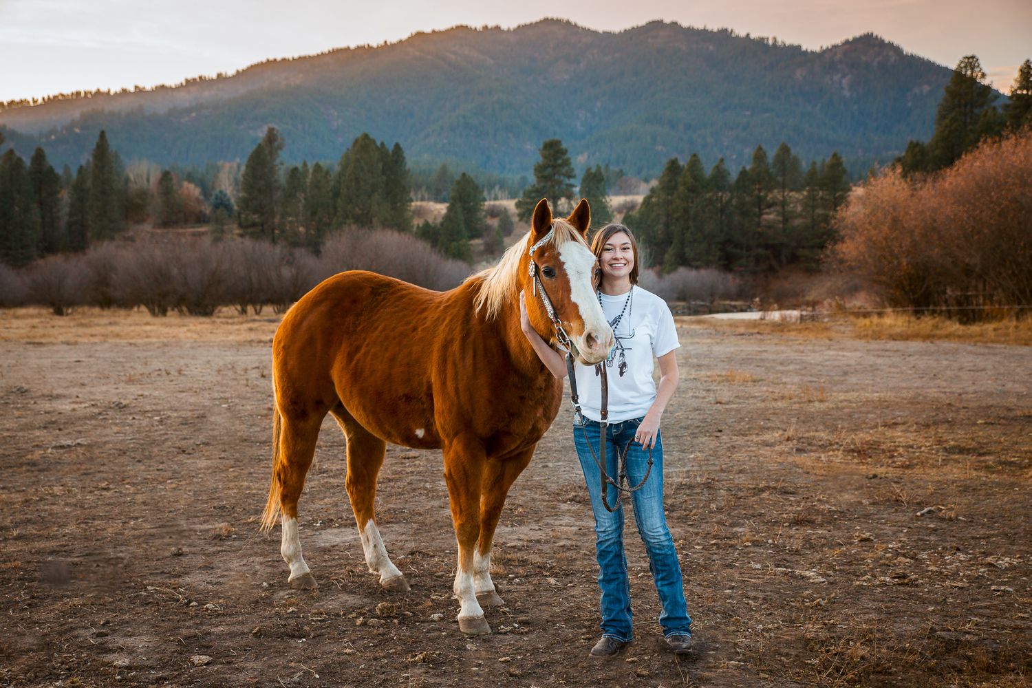 Boise senior photos featuring high school senior with her horse in a rustic outdoor setting in the Treasure Valley