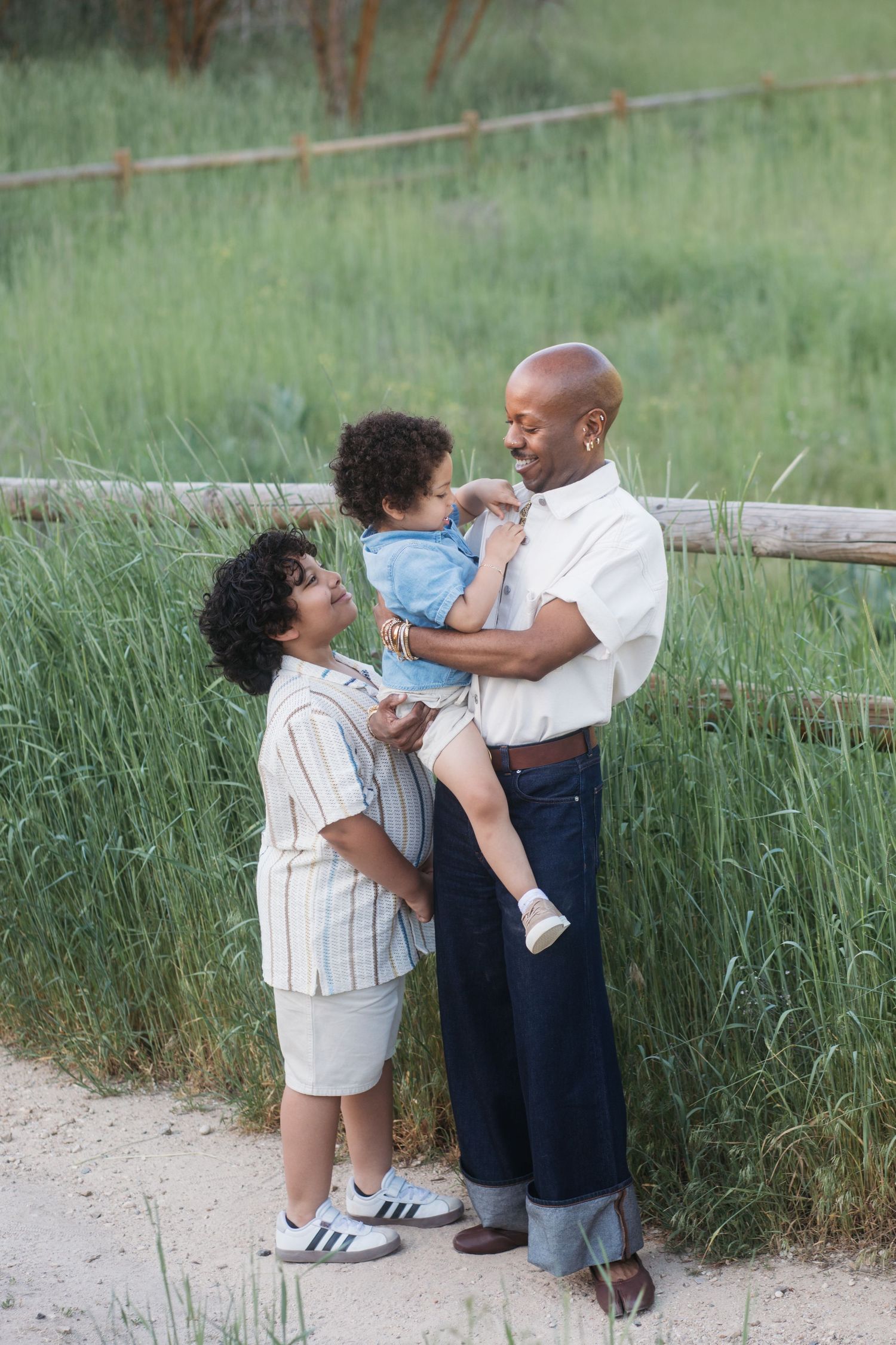 Uncle sharing a candid moment with grandchildren during an outdoor family session at Camel’s Back Park.