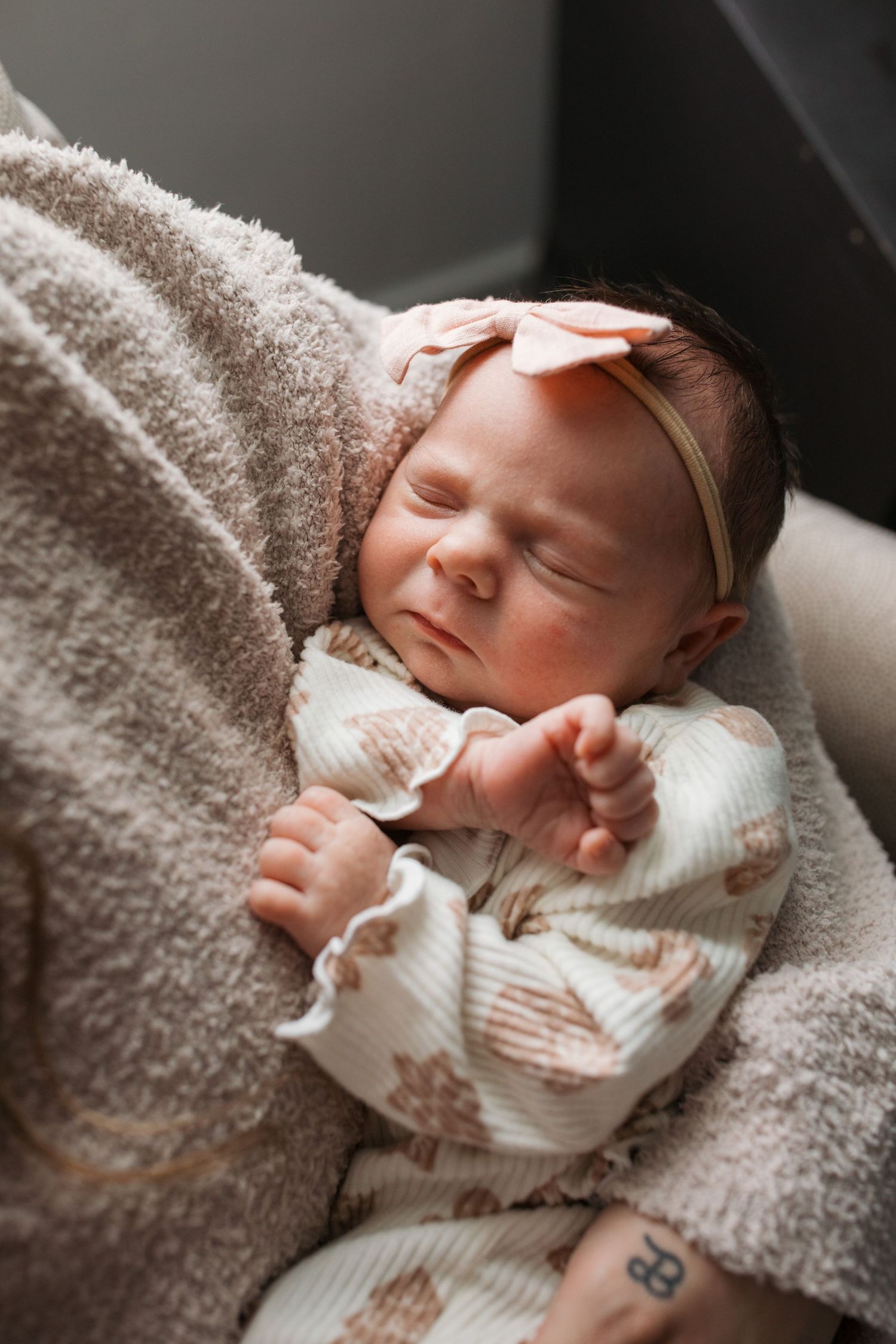 Newborn baby girl resting on her mother’s chest in soft natural light during their Middleton, Idaho lifestyle session.
