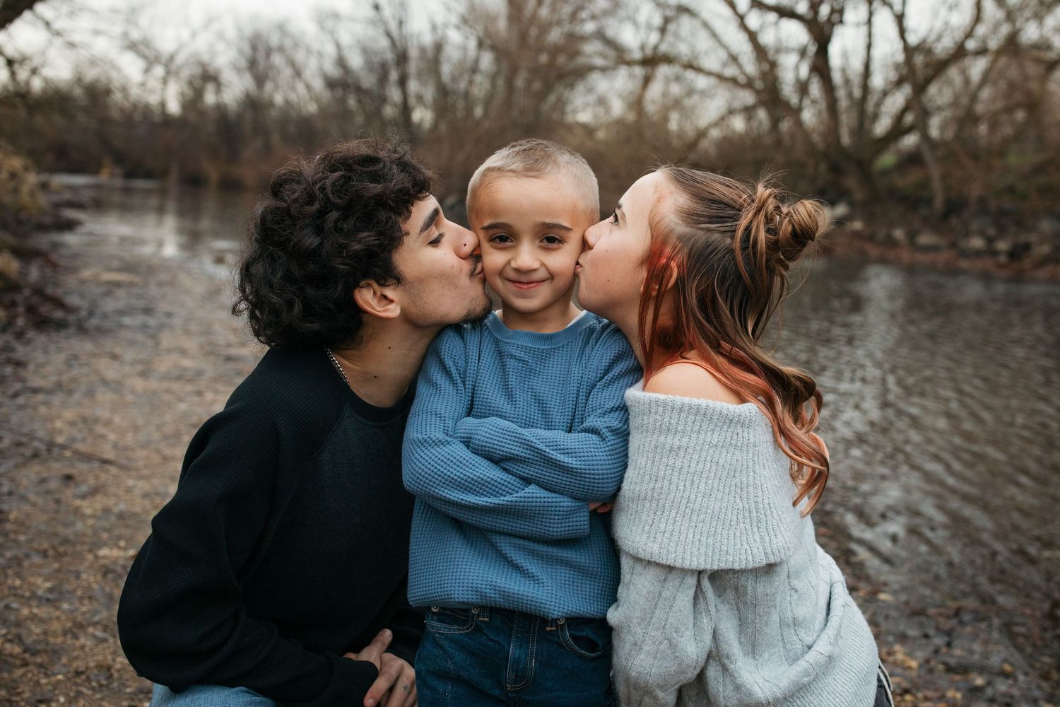 Candid sibling moment during a lifestyle family session along the Boise River in Eagle Idaho