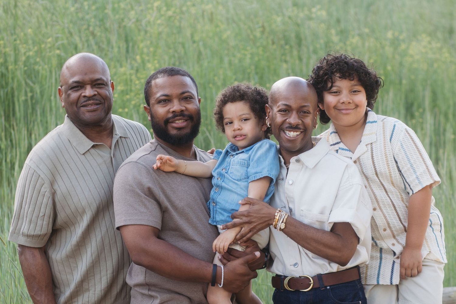 Father, grandfather, and children smiling together during an extended family session at Camel’s Back Park in Boise.