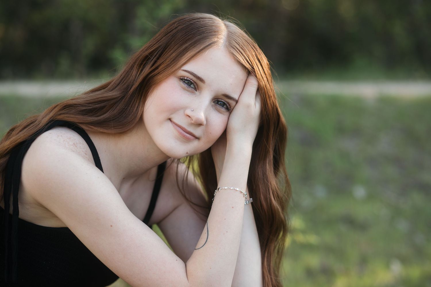 Boise senior portrait of girl resting head on hand in soft natural light during outdoor senior session