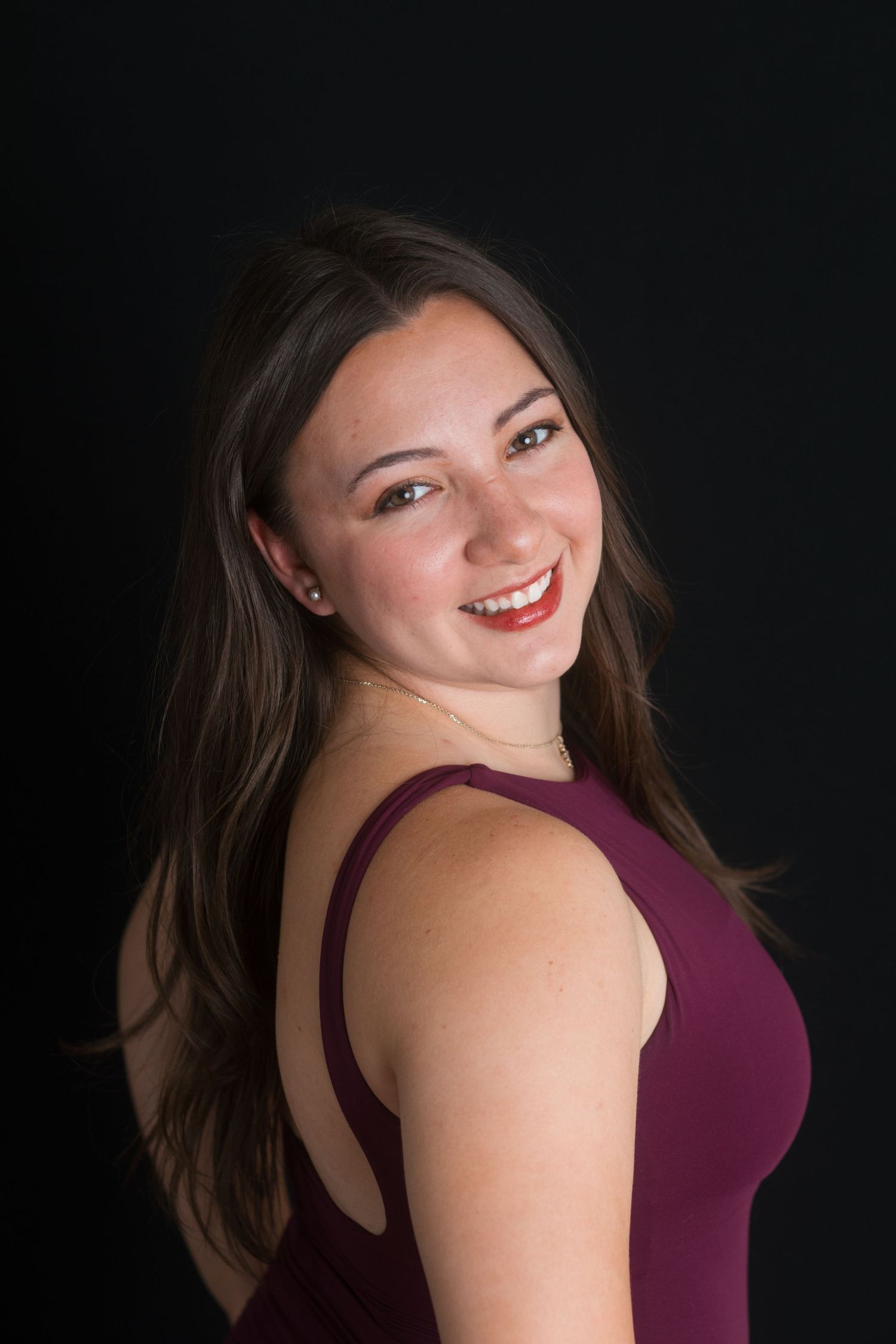 Professional female headshot with relaxed over-shoulder pose in studio, Boise Idaho photographer