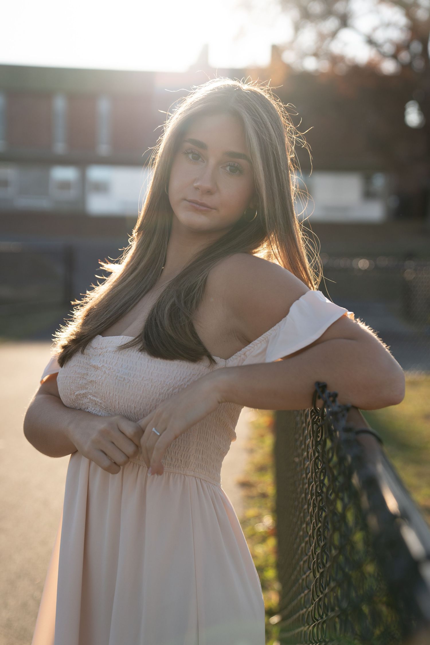 Maternity photo series in soft sunset lighting against a natural outdoor backdrop.