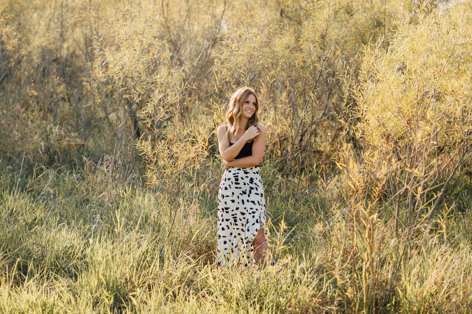 Natural outdoor portraits in golden sunlit grass.