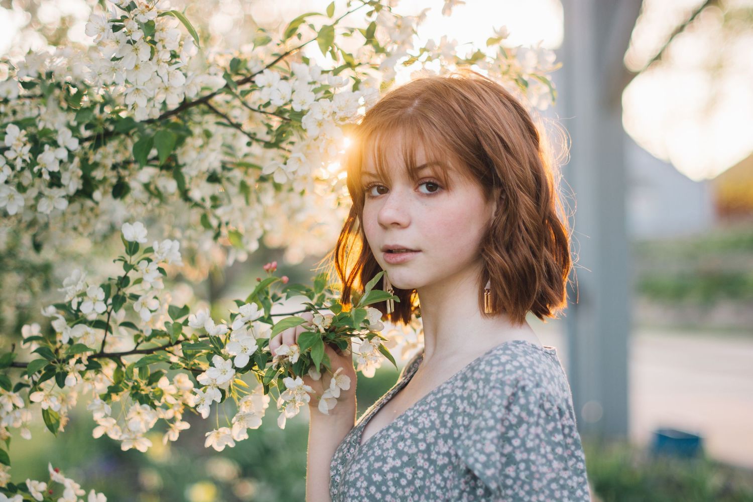 Portrait series in golden sunlight with autumn leaves and warm tones creating a dreamy atmosphere.