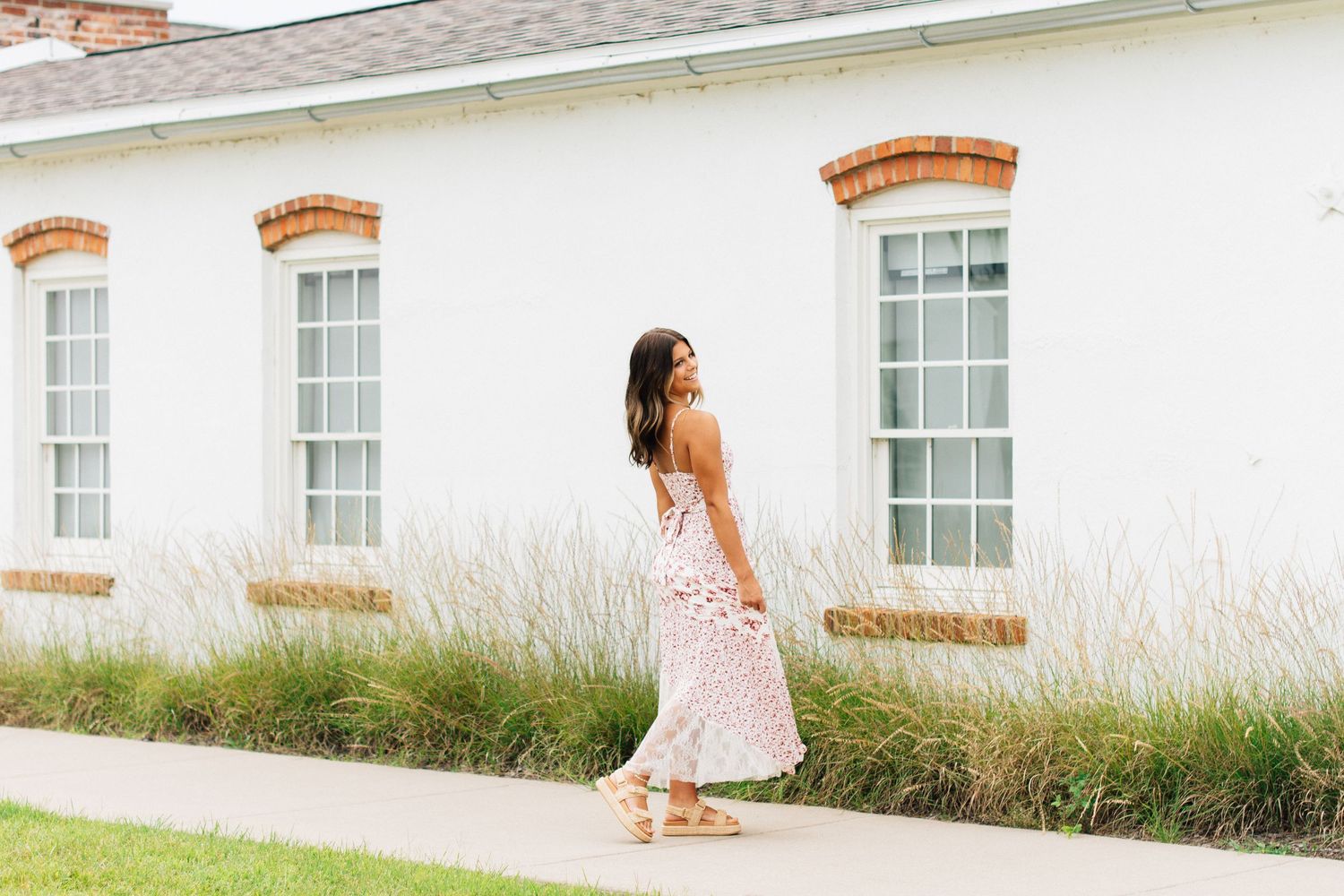 A white building with brick accents photographed from different angles in natural light.