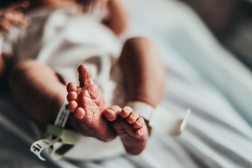 Closeup view of tiny newborn baby feet with hospital identification band.  Baby pictures Vigo County Union Hospital Terre Haute baby picture