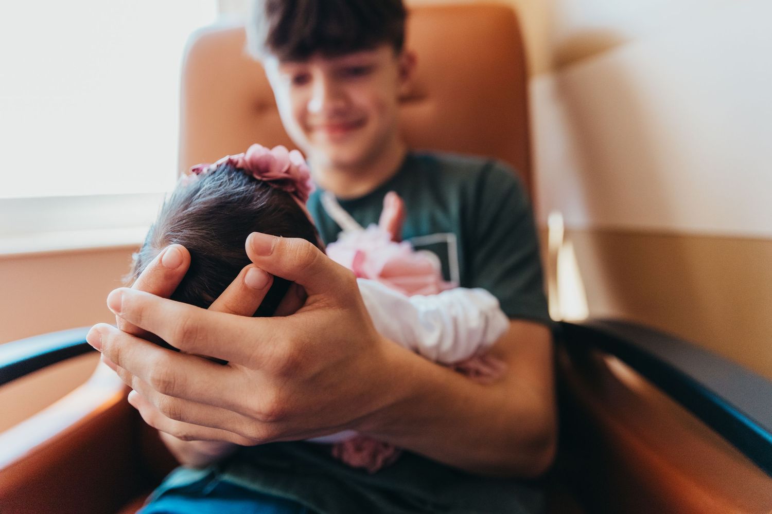 Professional newborn photo of big brother holding new sibling in hospital Union Hospital Terre Haute baby Photography