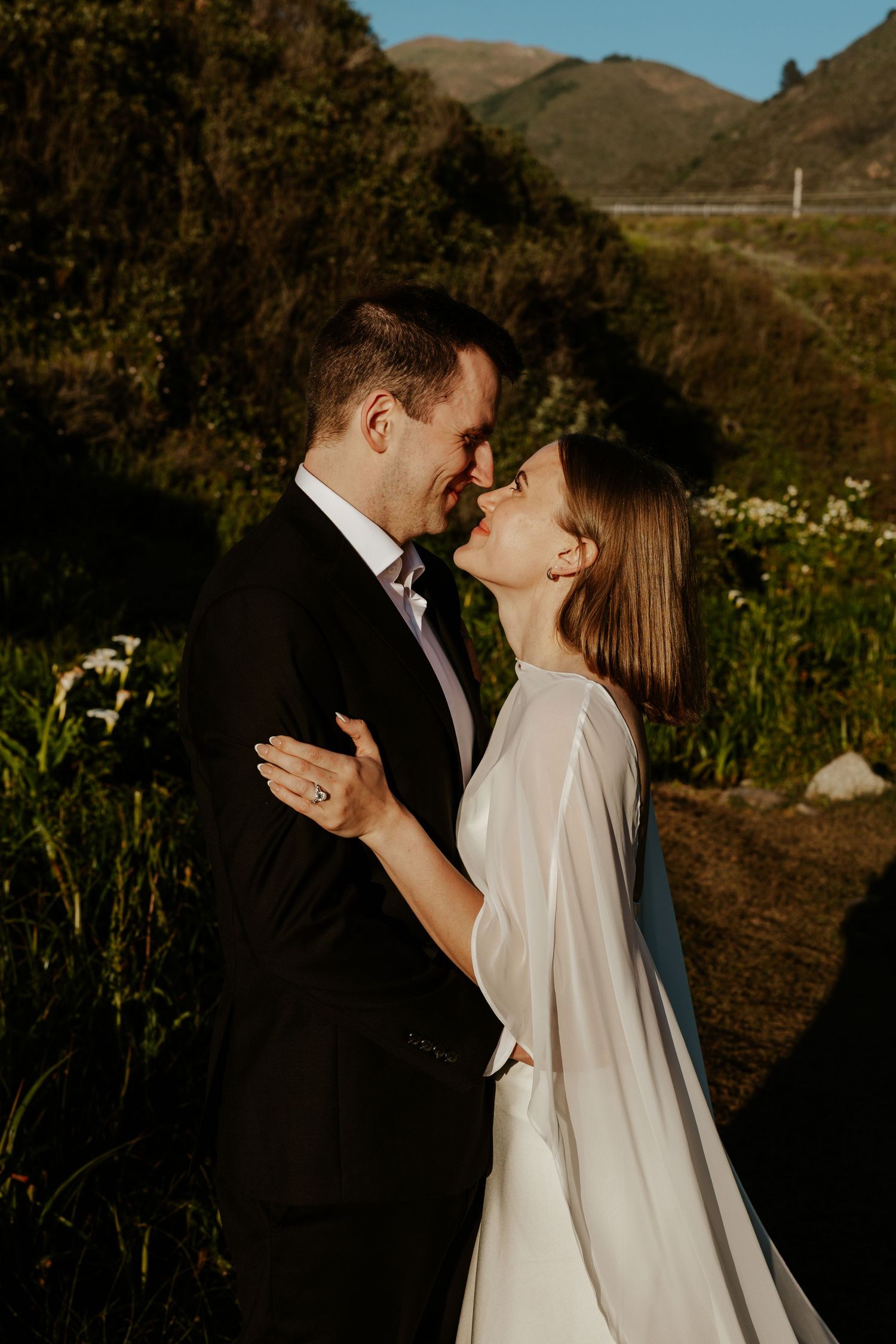bride and groom smiling and staring into each other's eyes in calla lily valley, big sur, carmel