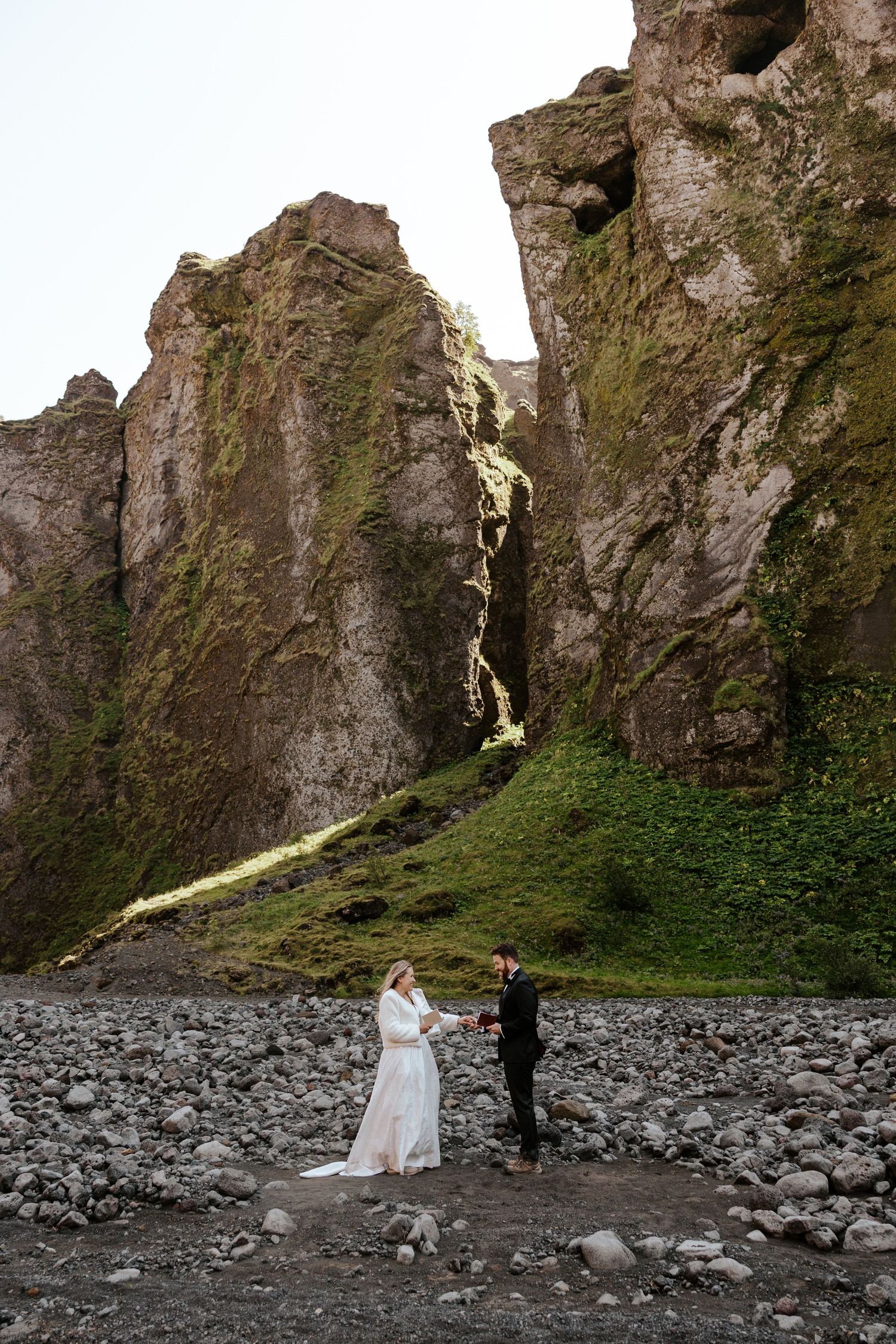 bride grabbing groom's hand while he recites vows in a canyon in Þórsmörk (Thórsmörk)  during iceland elopement