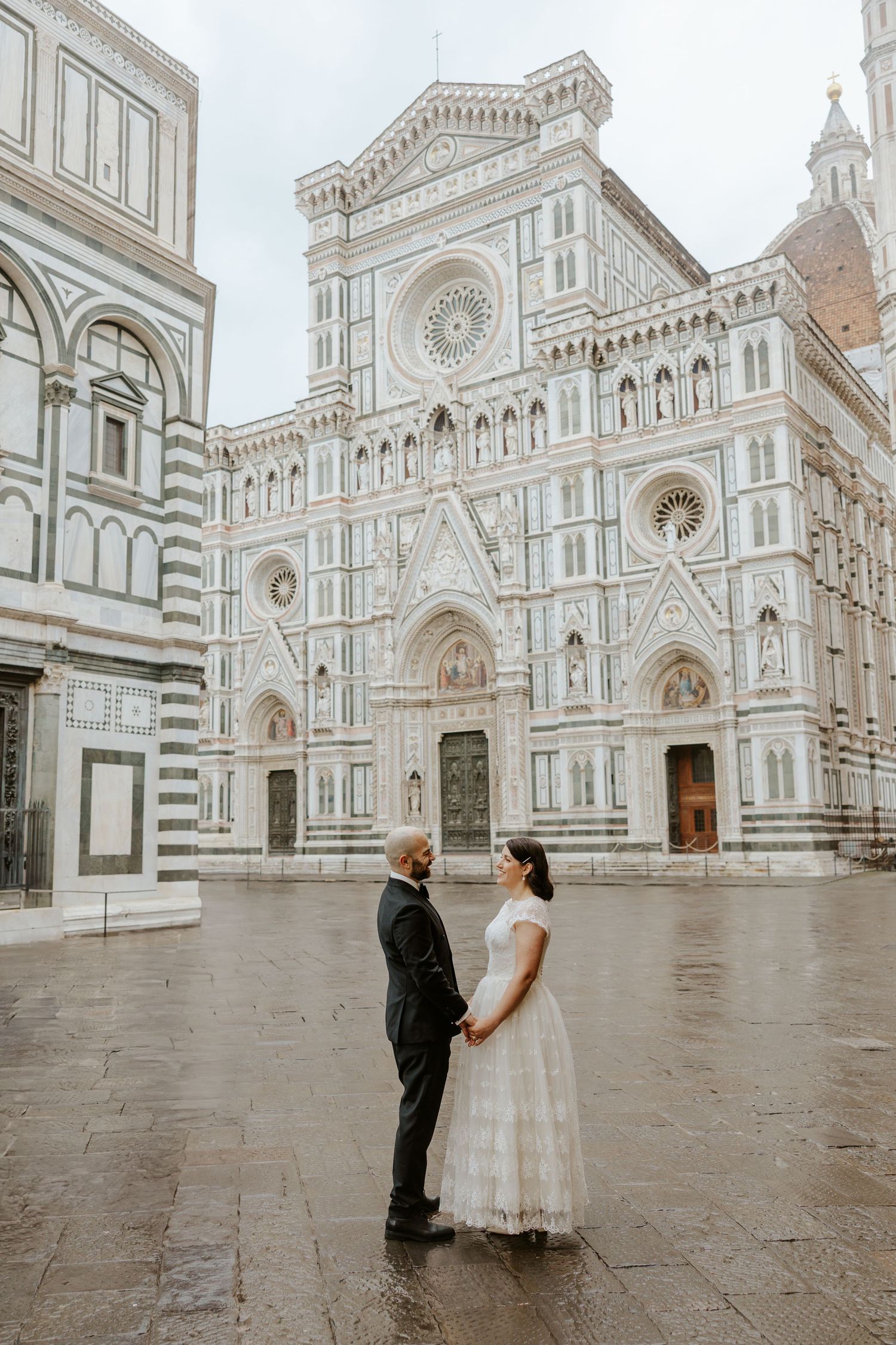 candid couple dancing in front of the duomo in florence, italy during their sunrise elopement in tuscany