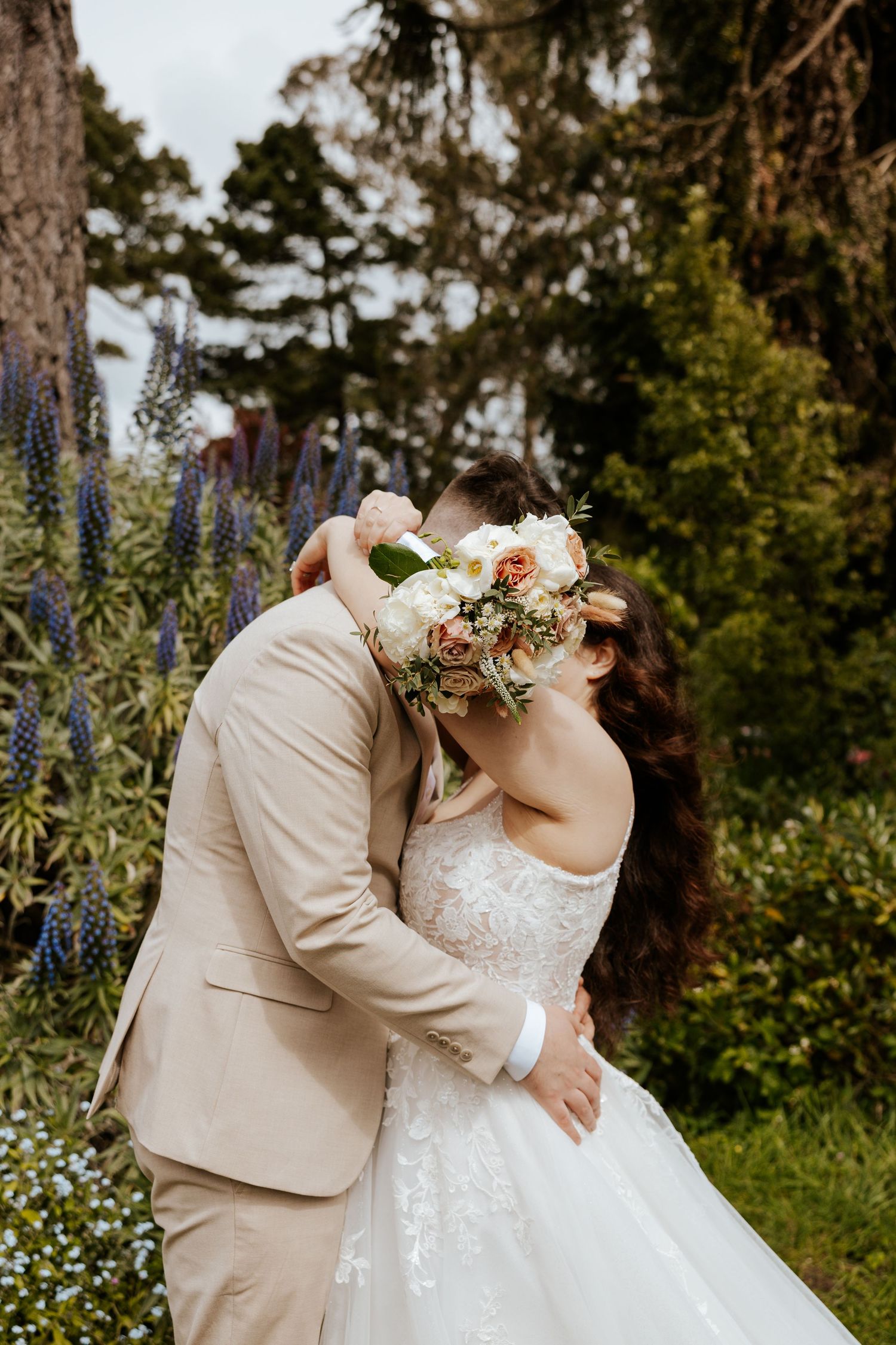 A couple kissing in San Francisco's golden gate park on their elopement day.