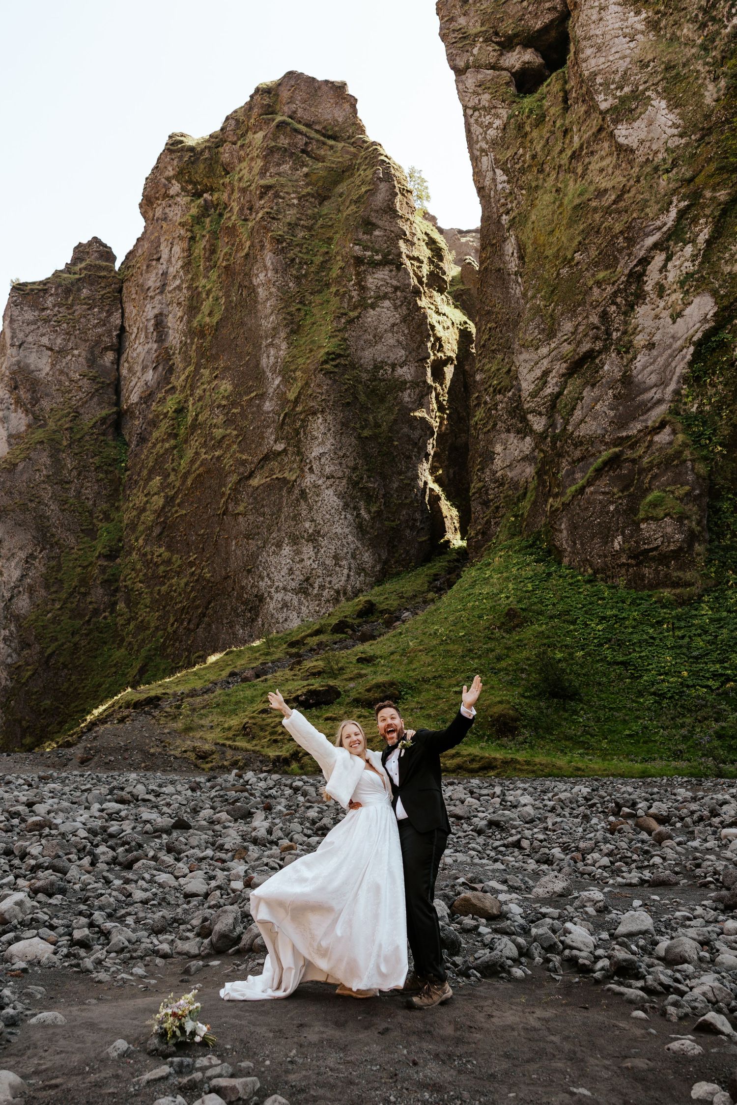 candid bride and groom celebrating after sharing vows in a canyon in Þórsmörk (Thórsmörk)  during iceland elopement