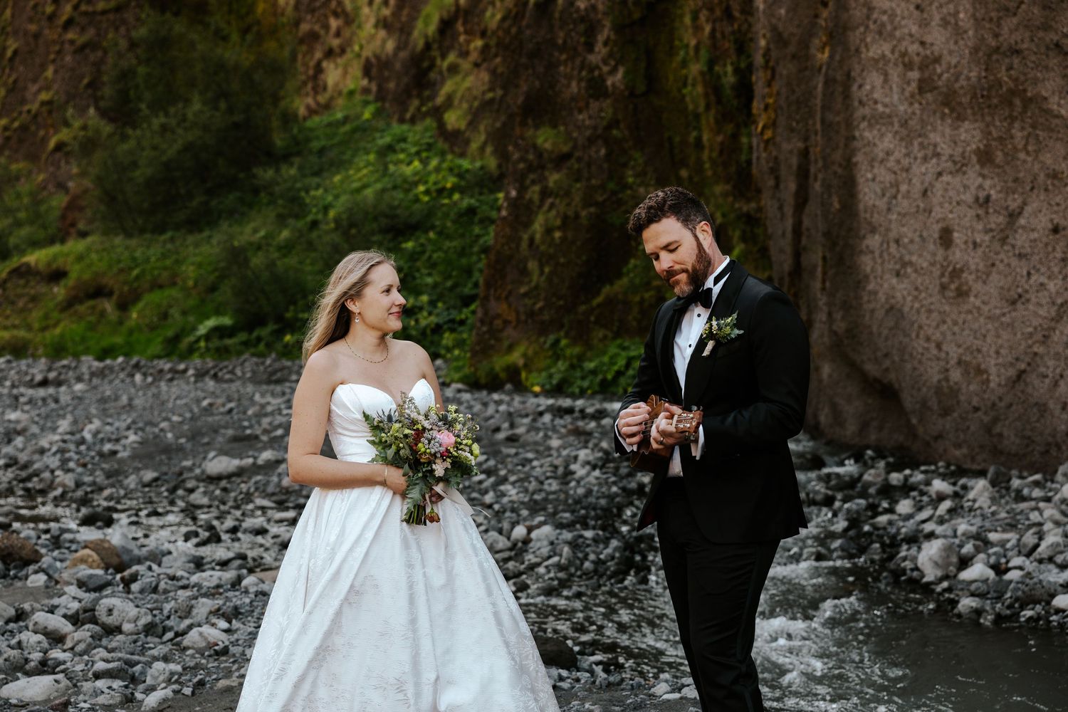 groom serenading bride by playing ukulele and a canyon in iceland