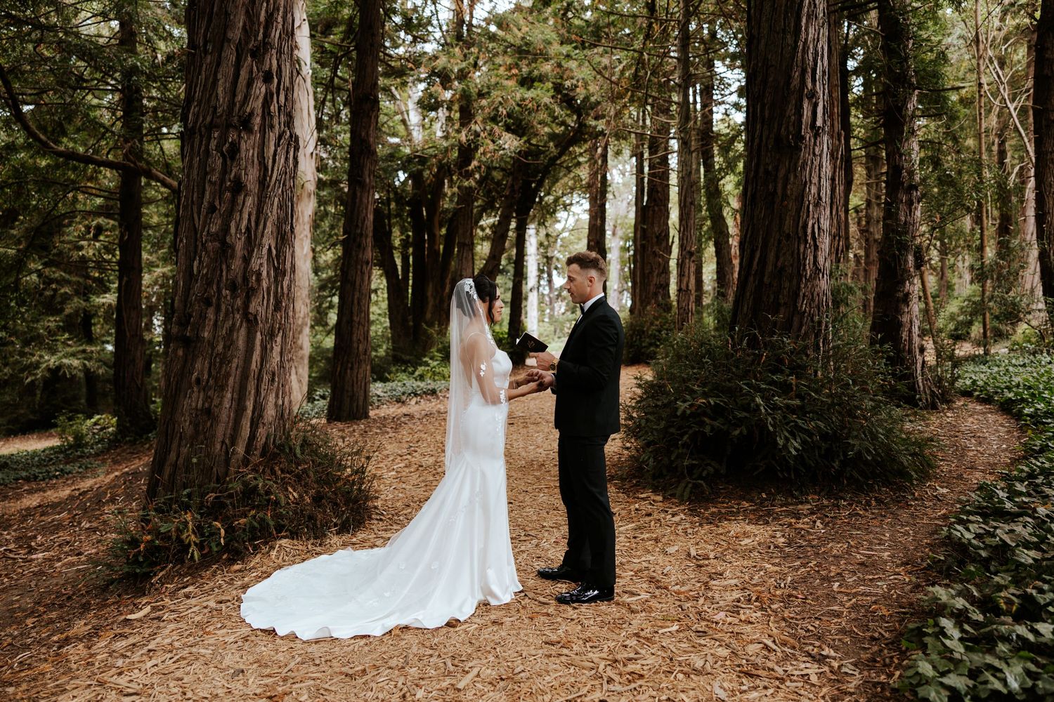 groom sharing wedding vows with bride in redwood grove in golden gate park during san francisco elopement day