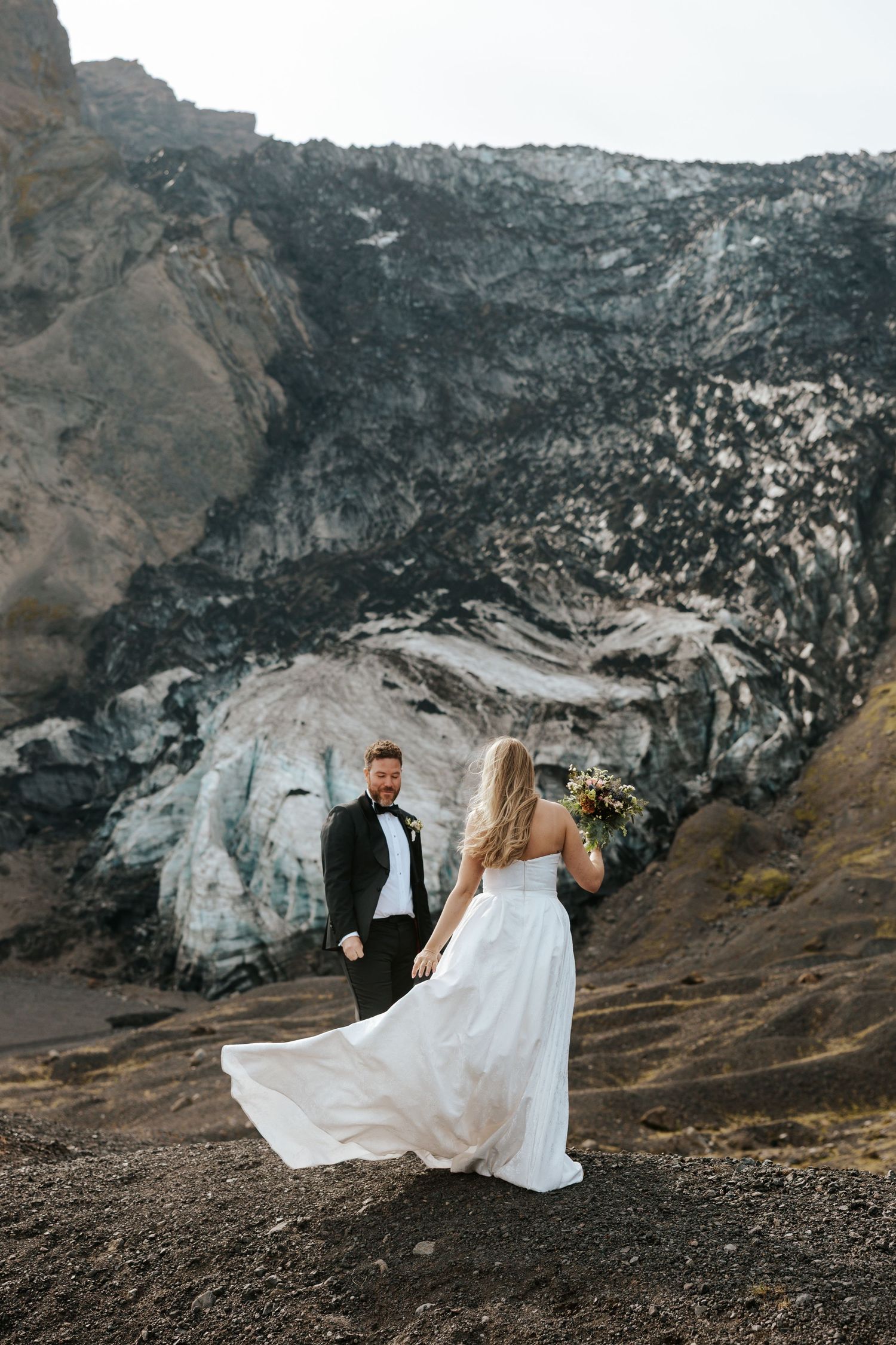 groom's first look at his bride on a mountain in Iceland