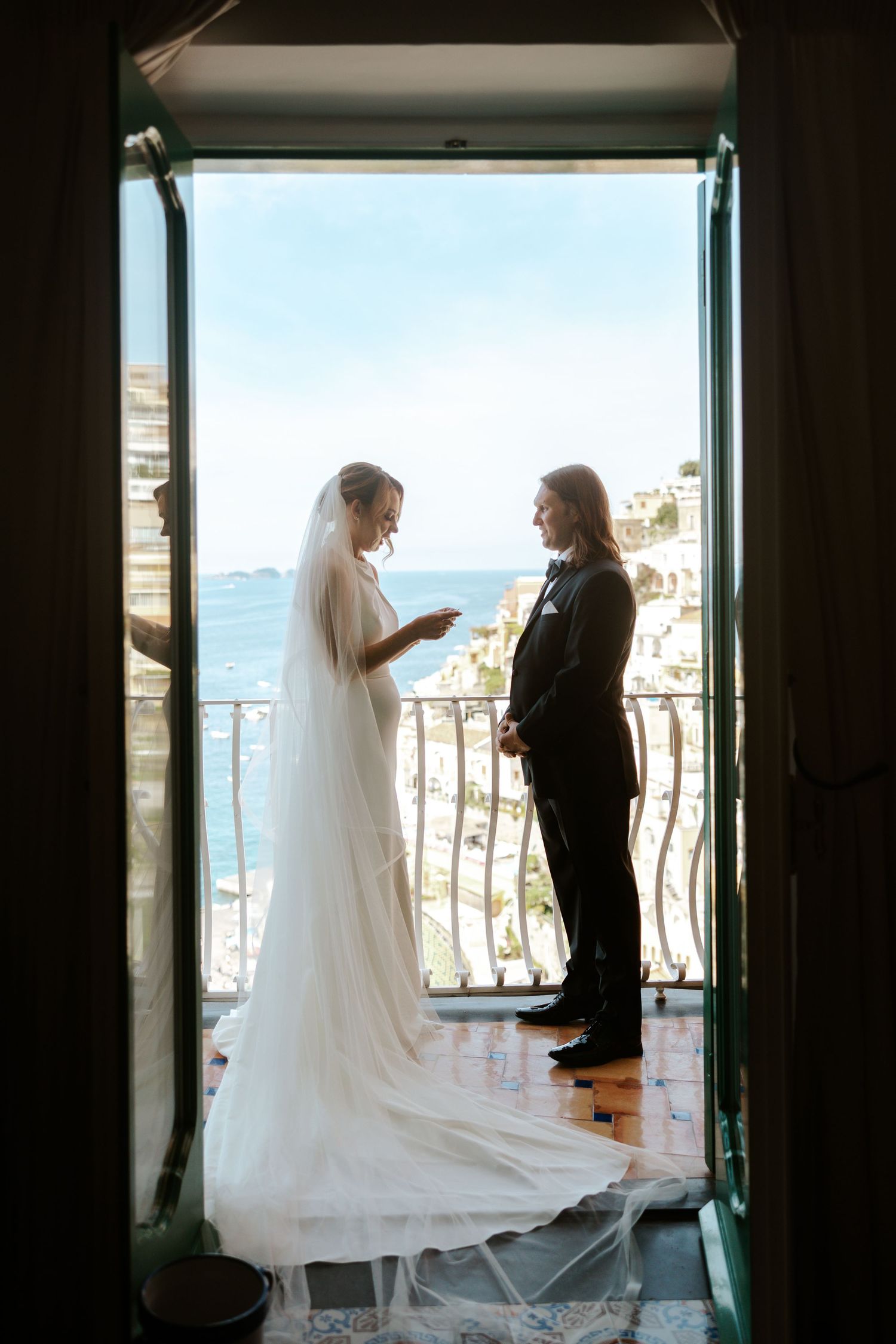 bride and groom sharing vows while on balcony at le sirenuse hotel in positano on their italy elopement day