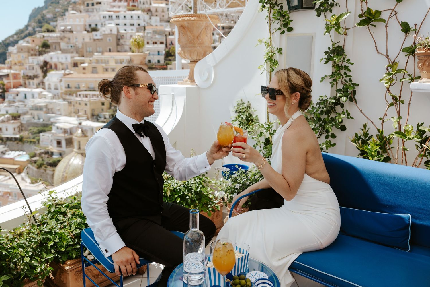 couple cheers-ing their cocktails at Franco's Bar in Positano during positano elopement day
