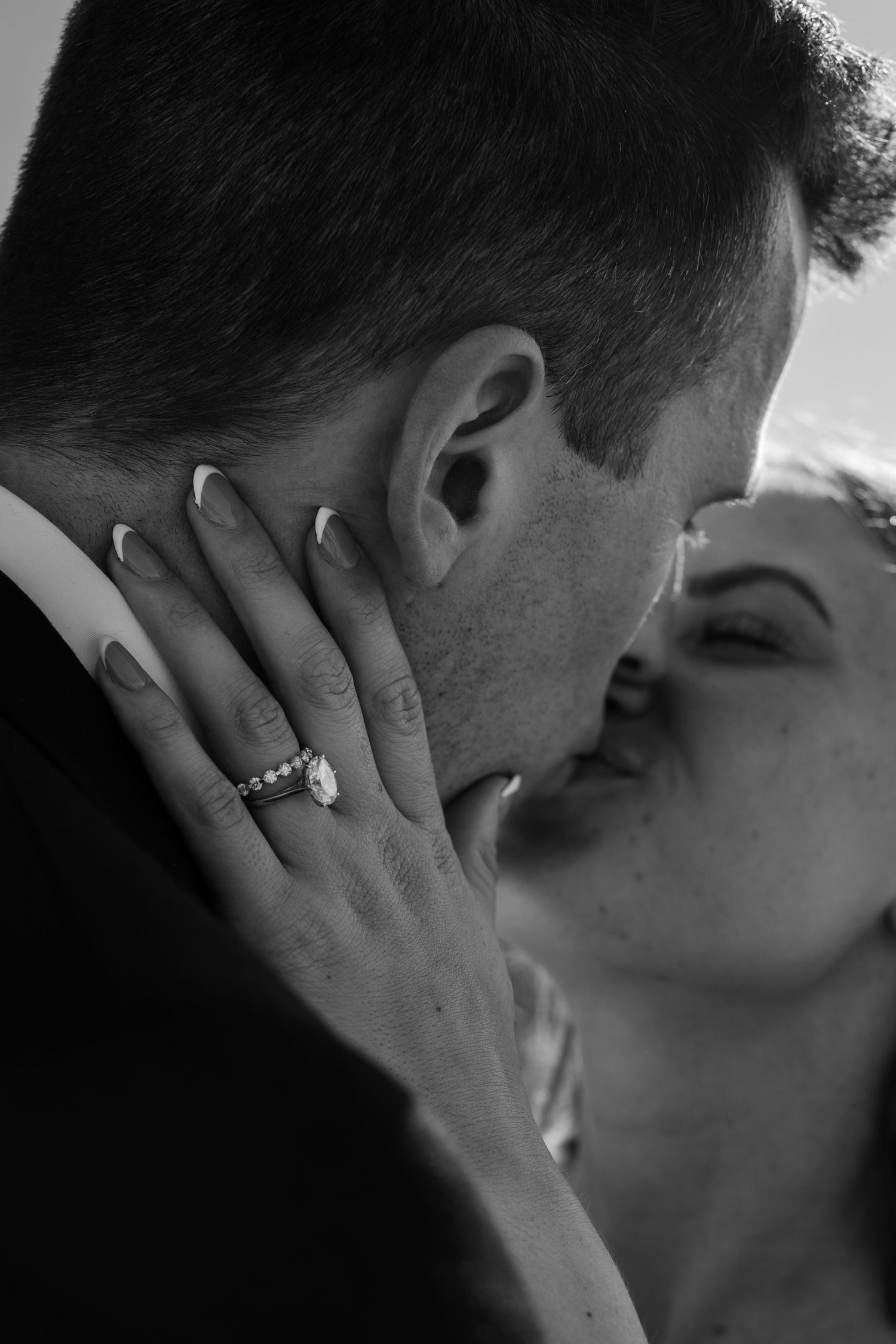 close up ring shot as bride and groom kiss