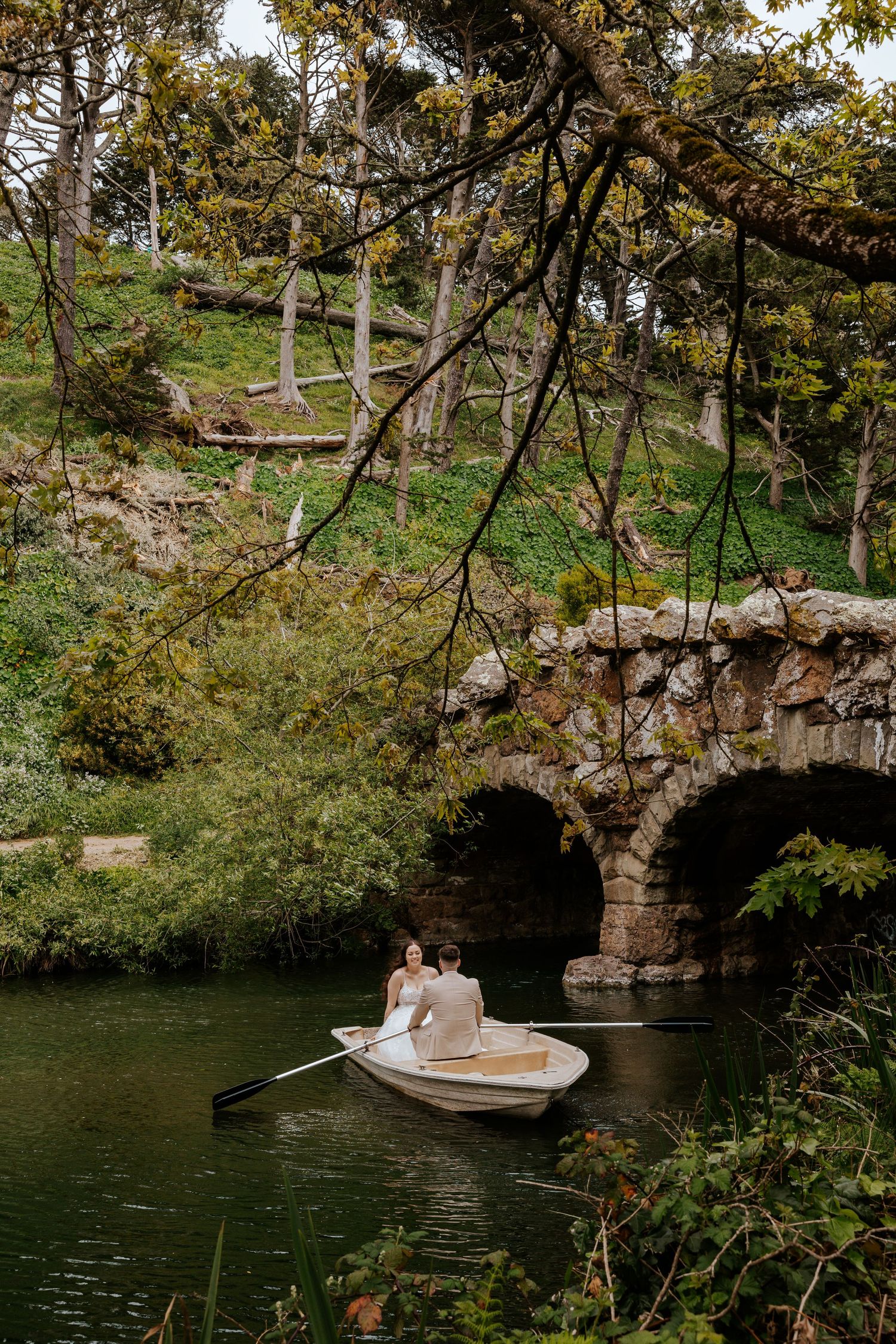 San Francisco elopement - a couple is on a romantic row boat in golden gate park soaking up just being married
