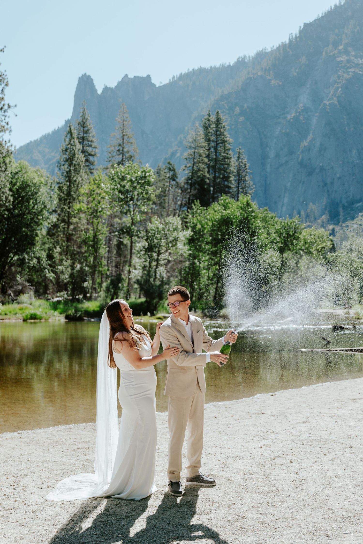 candid yosemite elopement photographer. couple popping champagne to celebrate