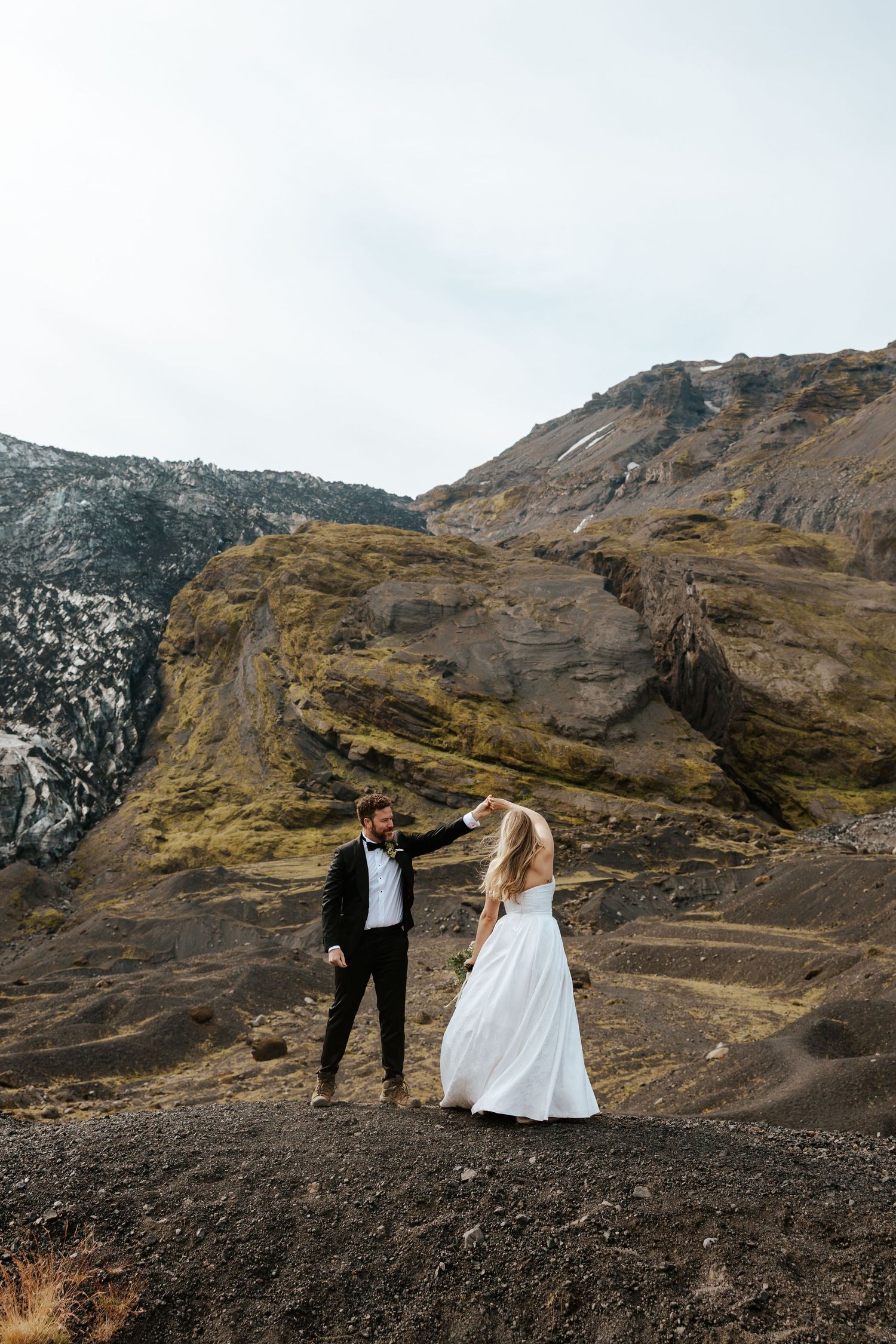 groom twirling his bride on a mountain in Þórsmörk (Thórsmörk), Iceland