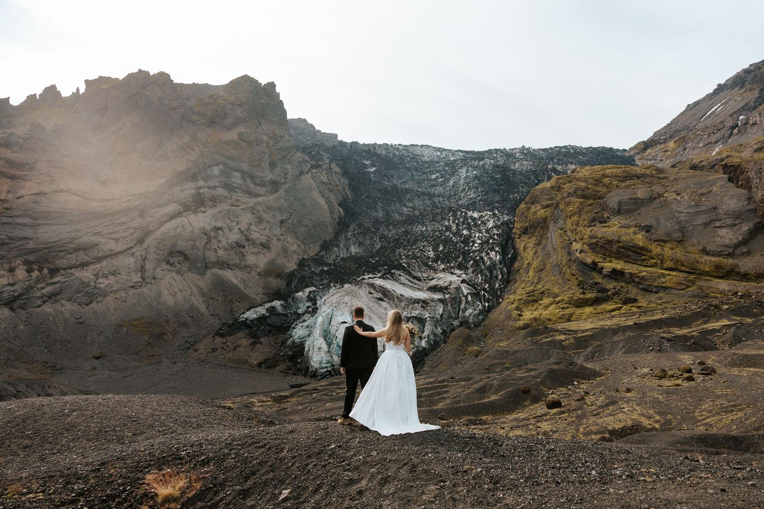 sweet moment of bride tapping the shoulder of groom right before the first look during Iceland elopement