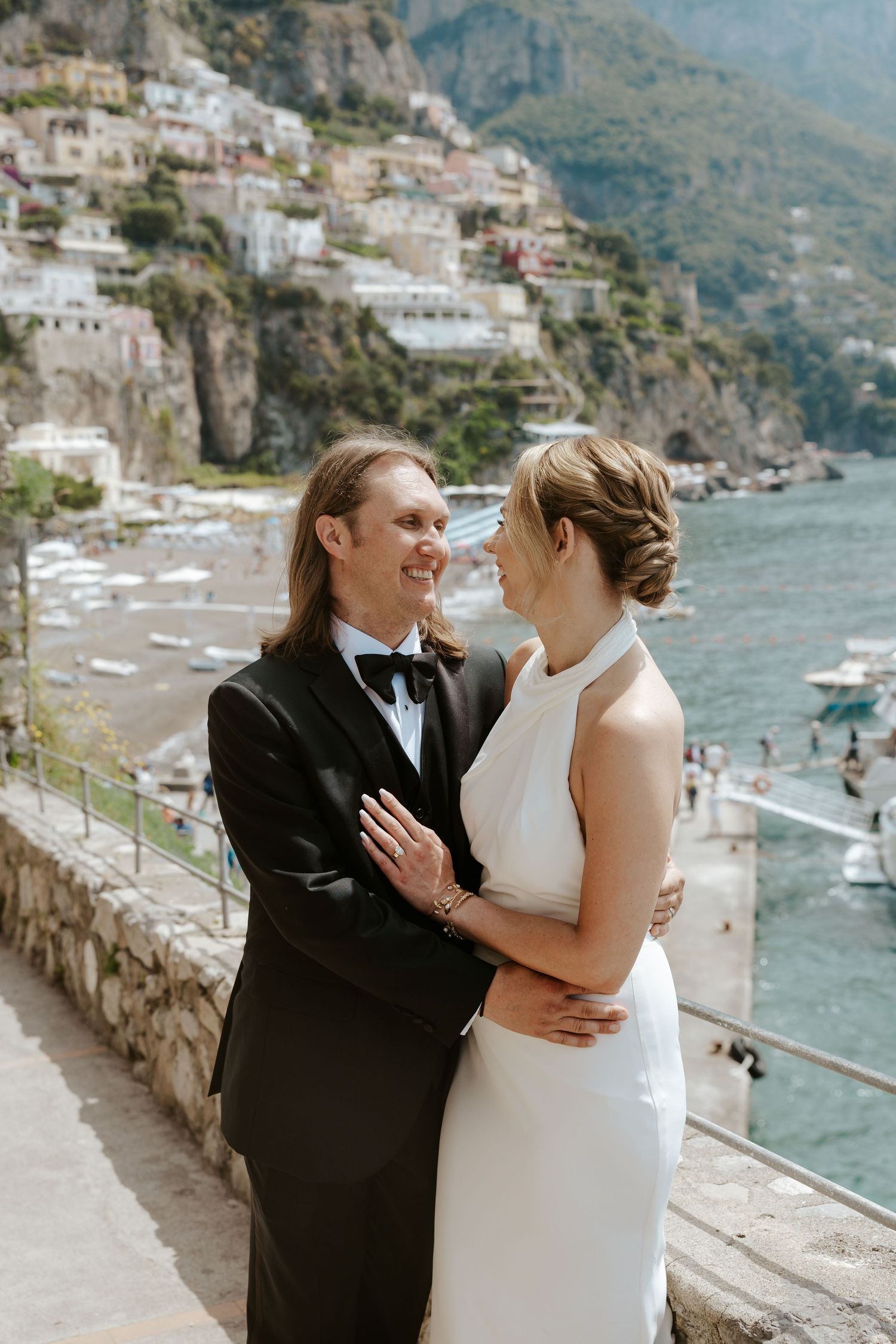 bride and groom looking at each other with a view of Positano during Italy elopement day