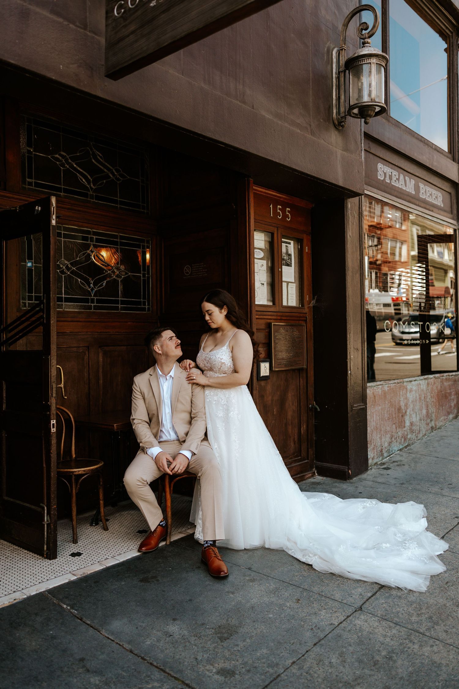 Romantic San Francisco elopement - a couple is getting cozy in a bar. Authentic elopement photos