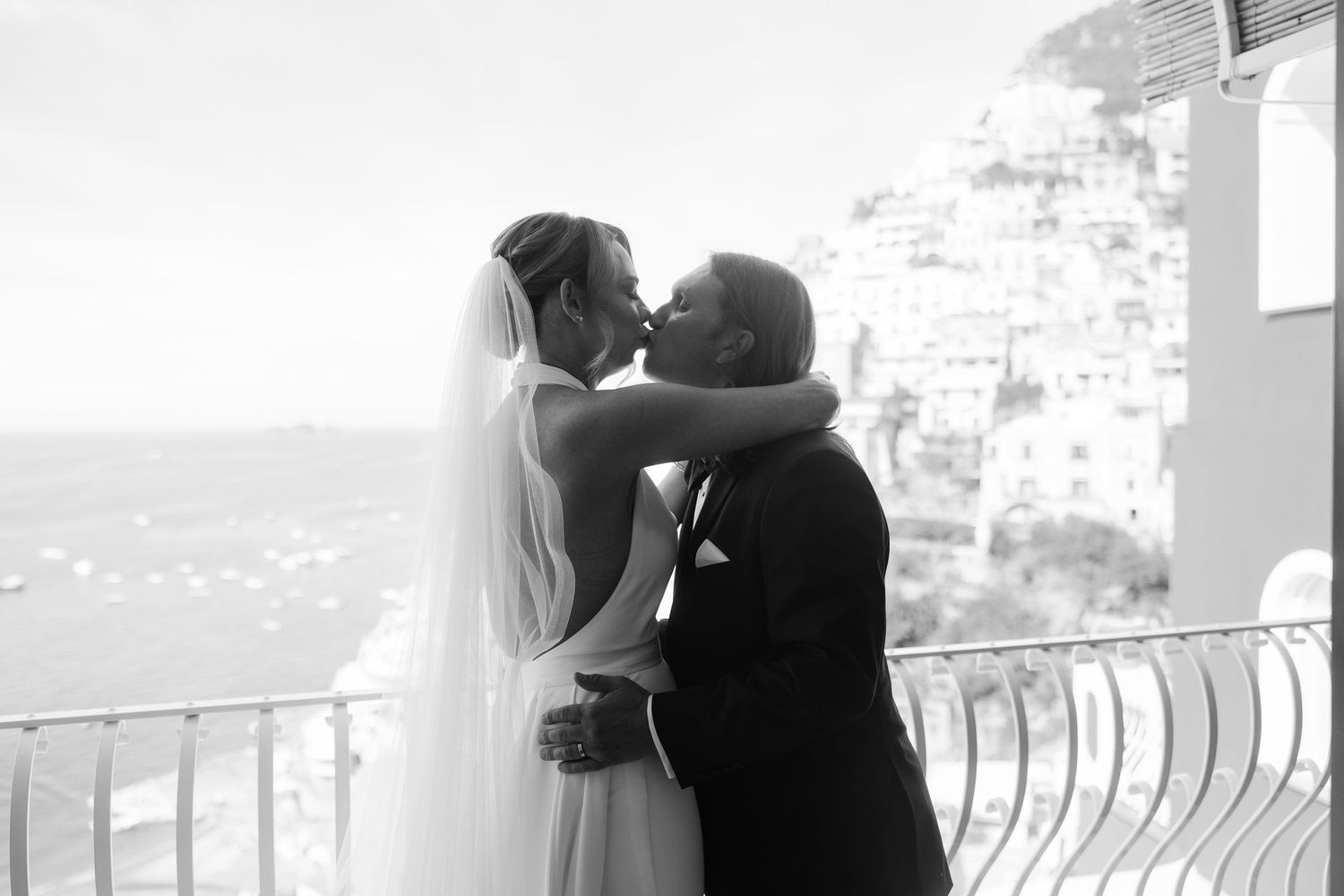 black and white photo of bride and groom first kiss after their ceremony during their Positano Elopement day