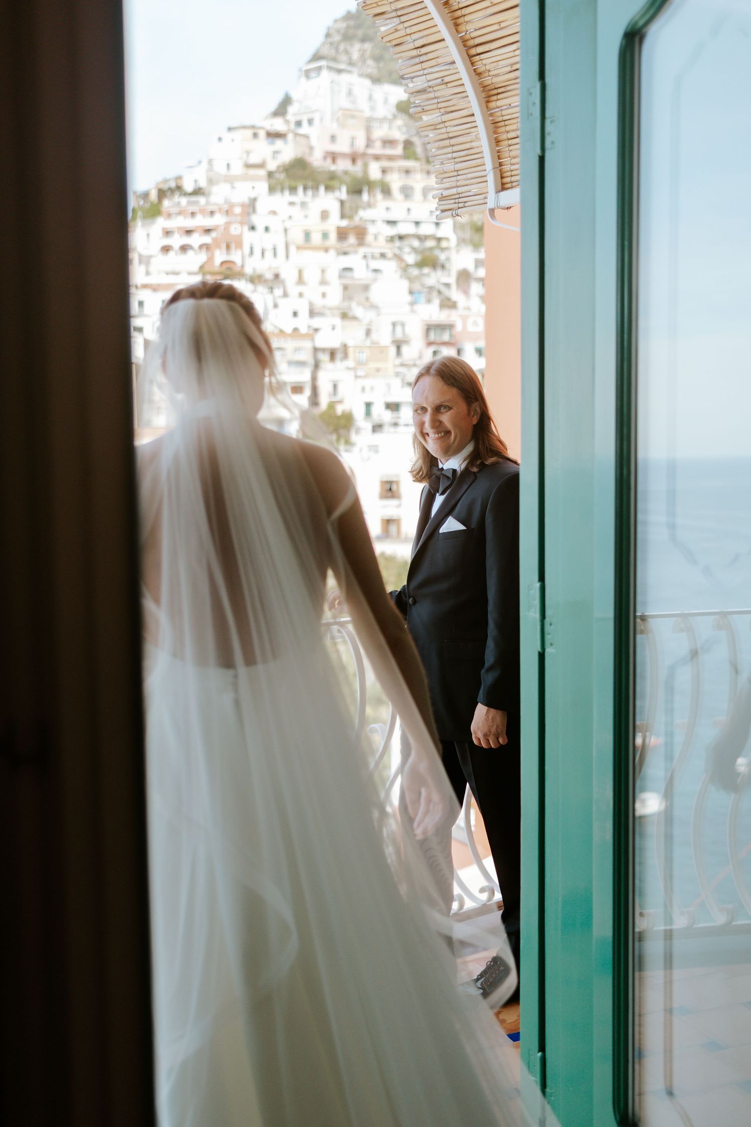 first look with bride and groom on the balcony at Le Sirenuse Hotel overlooking Positano, Italy
