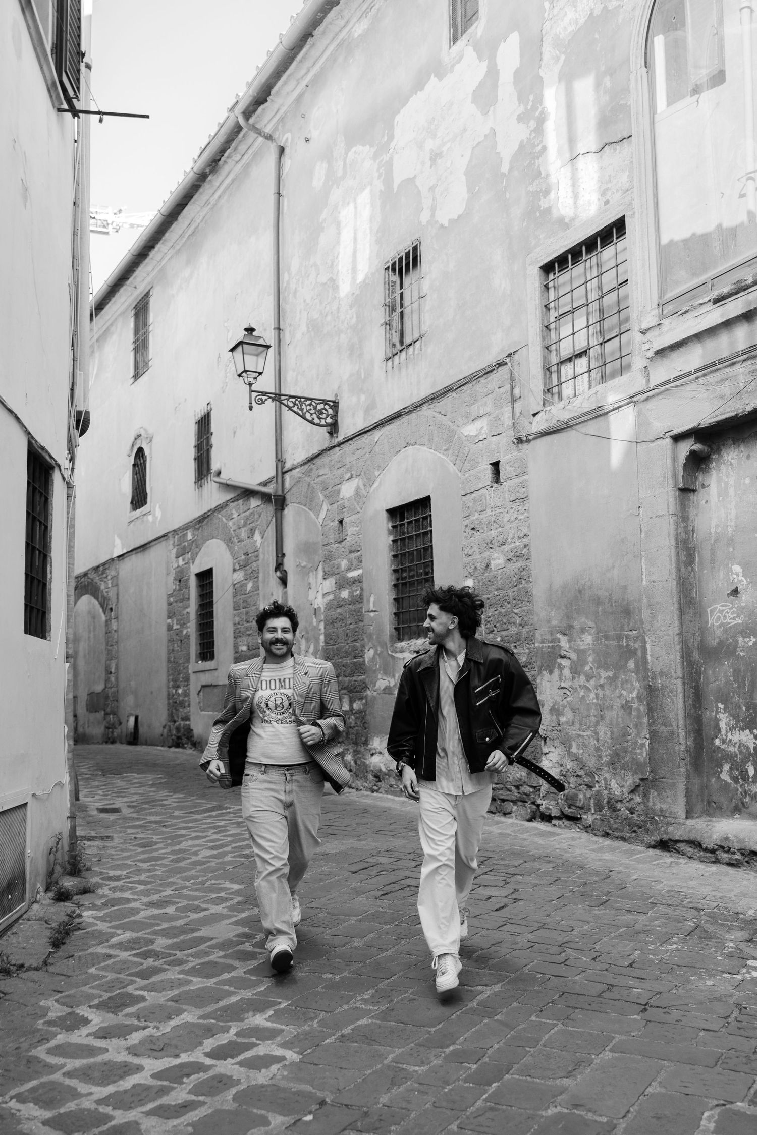 couple running through the streets of florence on their all day elopement in tuscany italy