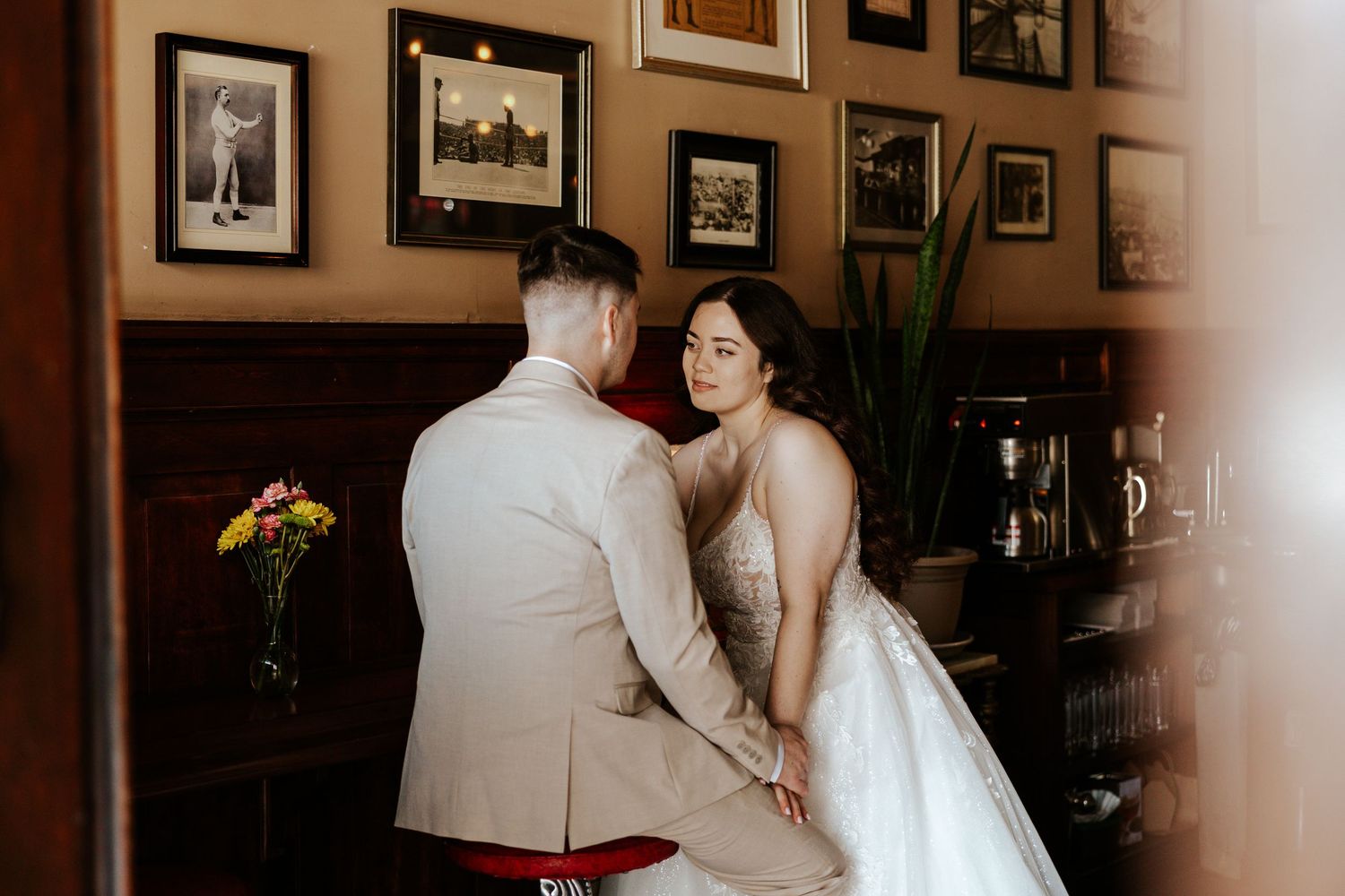 A couple getting cozy at a bar in San Francisco after eloping in the city