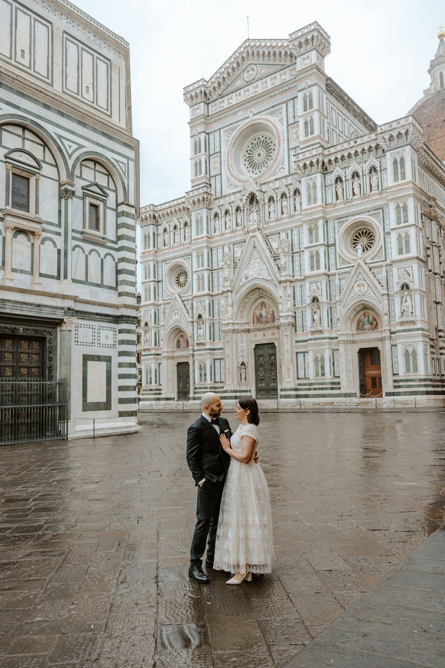 in love couple on their Florence Italy elopement day standing in front of the Duomo Cathedral of Santa Maria del Fiore