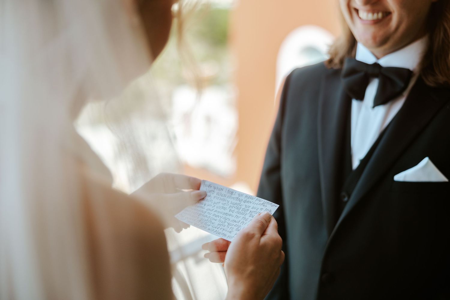bride reading vows during their Positano elopement ceremony on the balcony of their hotel