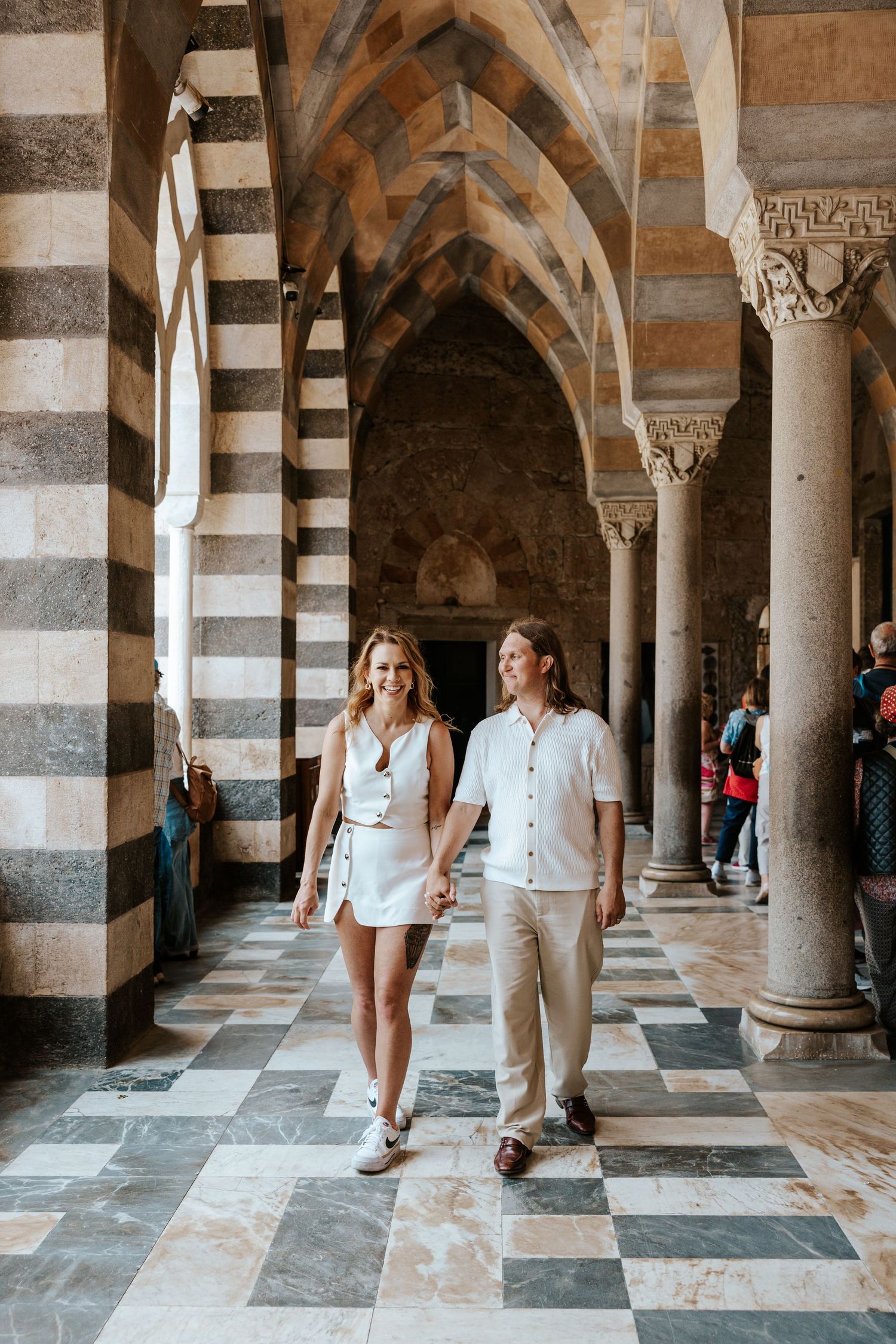 couple walking at the amalfi duomo from italy elopement photographer