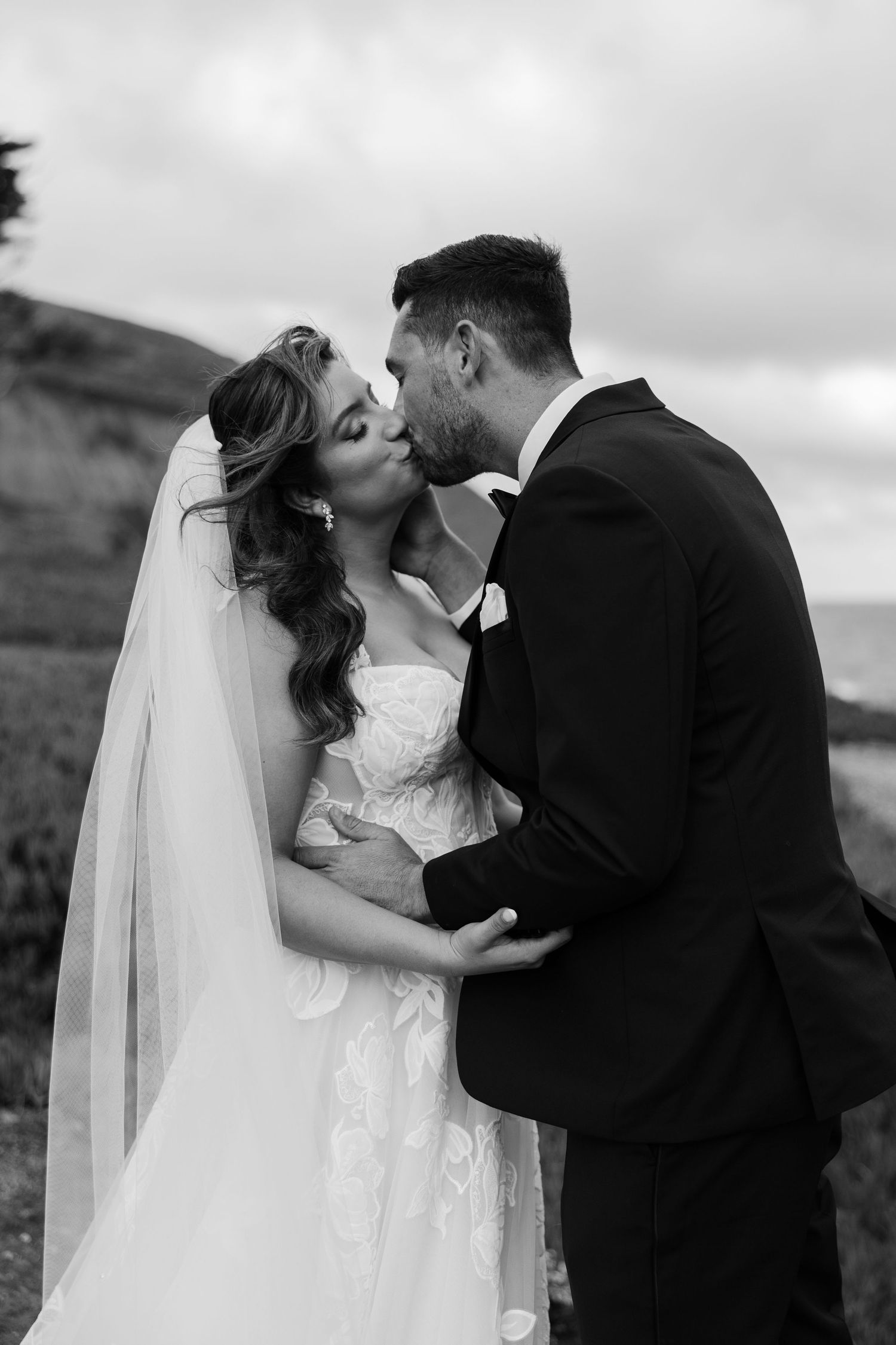 black and white photo of elopement couple kissing on cliffs during bay area elopement day