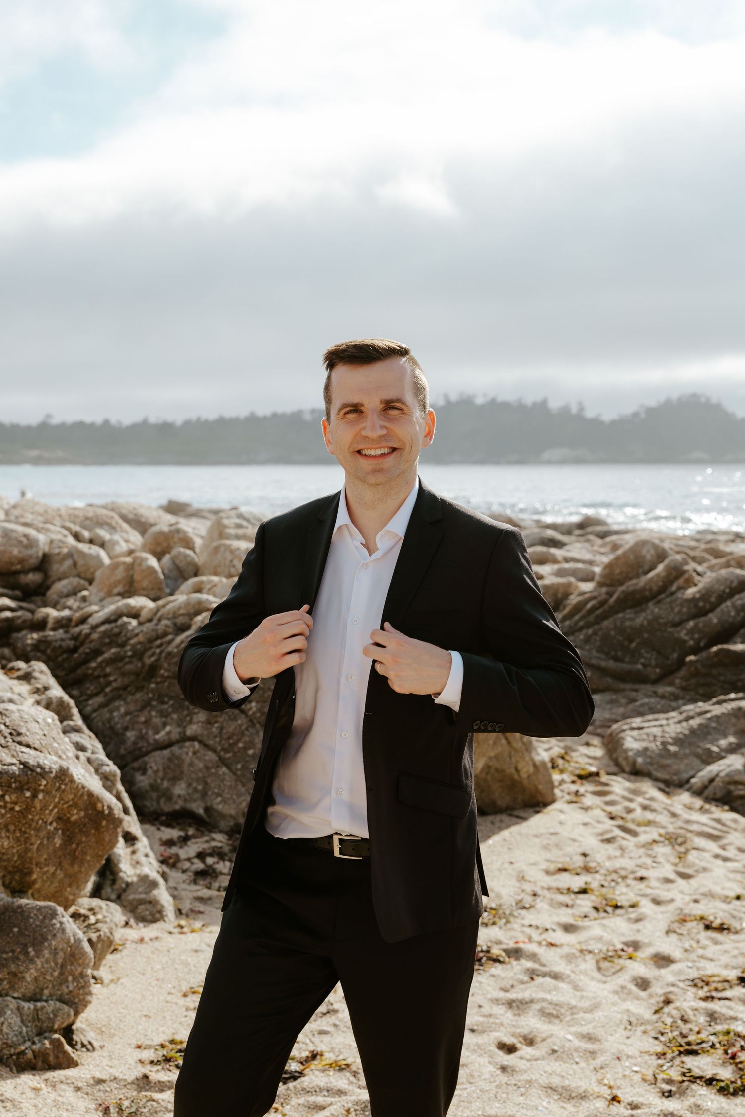 portrait of groom on beach
