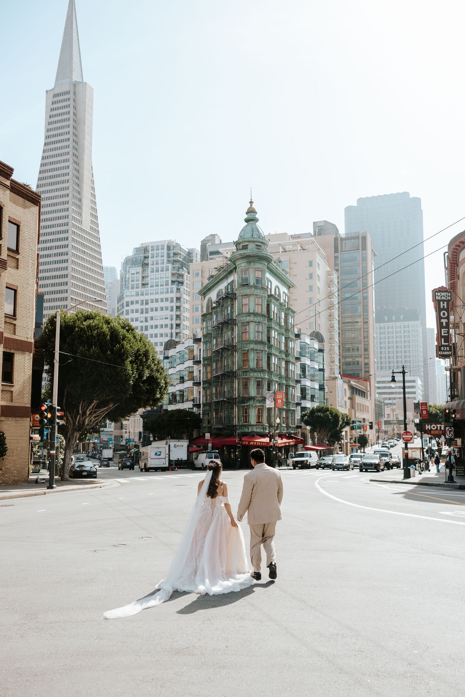 bride and groom running in the street in north beach san francisco during their elopement day