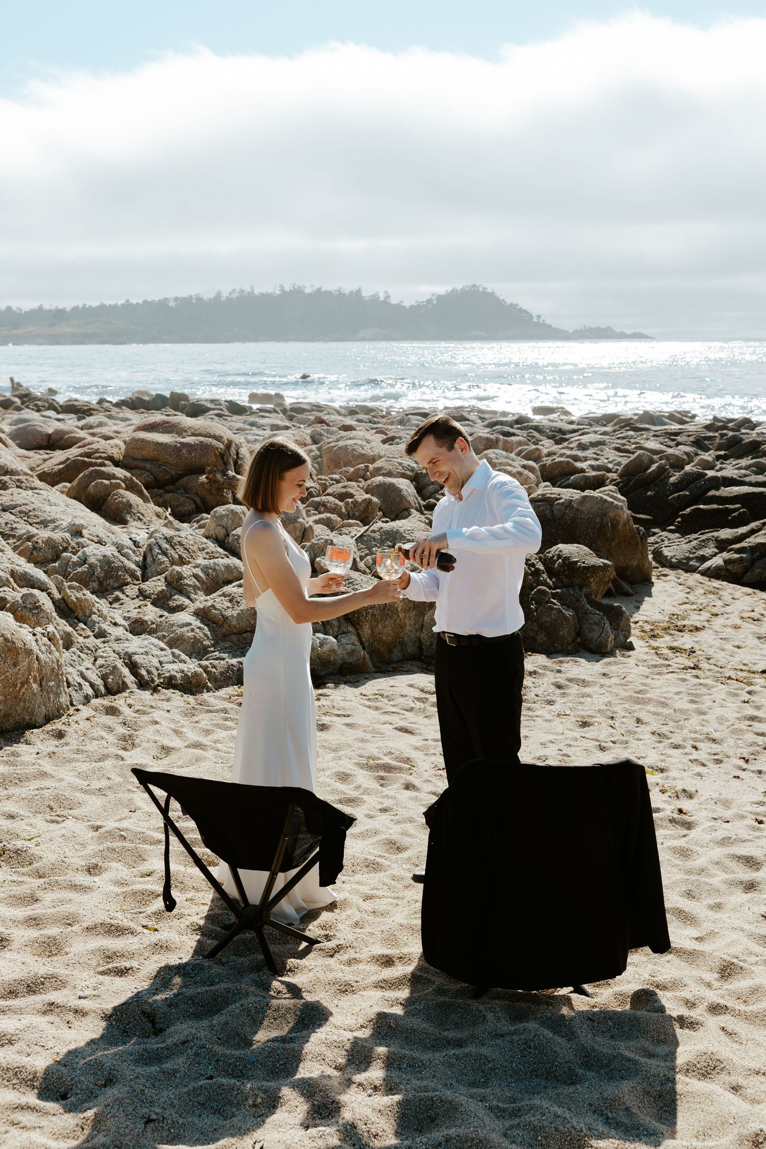 groom pouring diet pepsi for bride during beach elopement