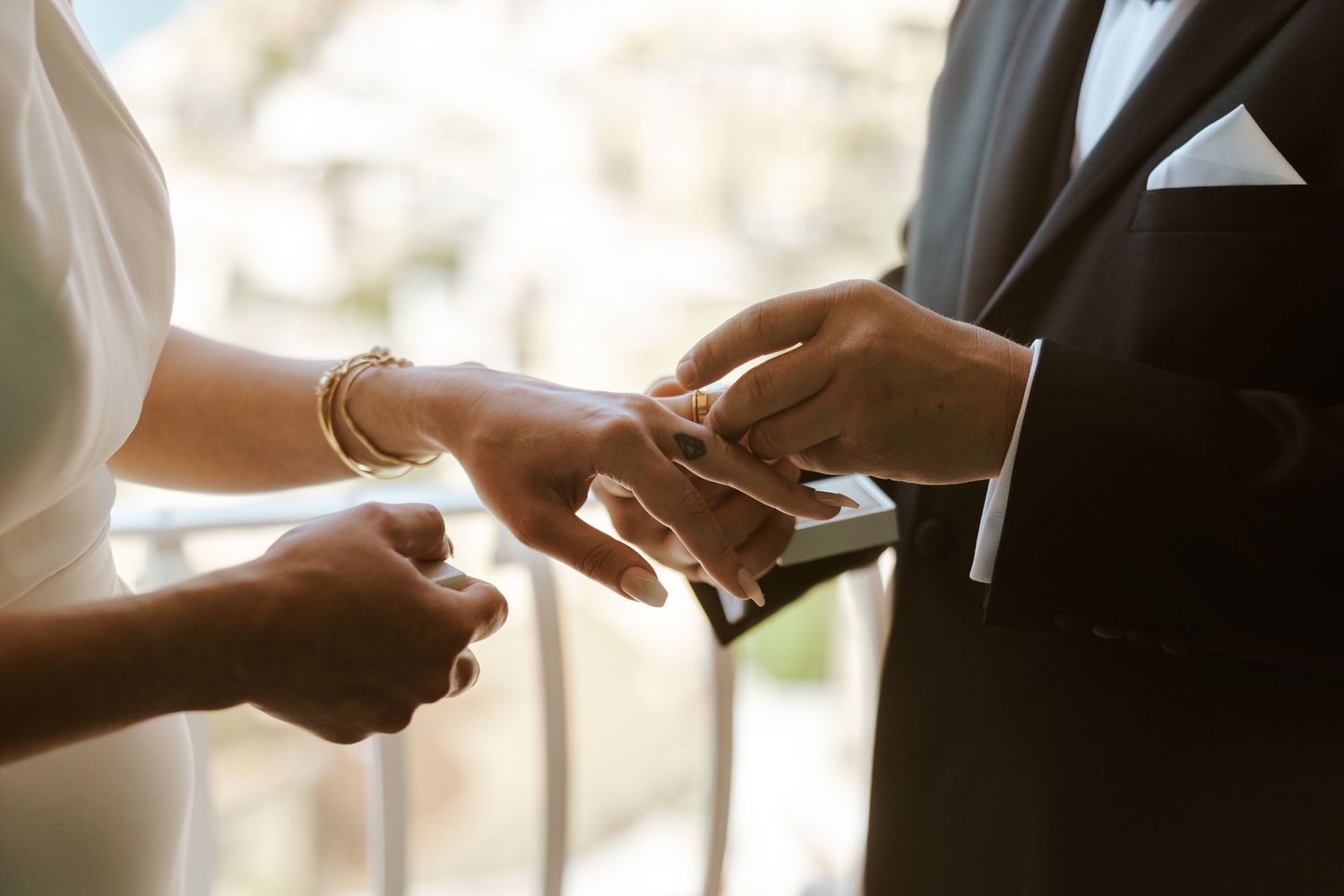 groom putting ring on bride's finger during amalfi coast, elopement ceremony