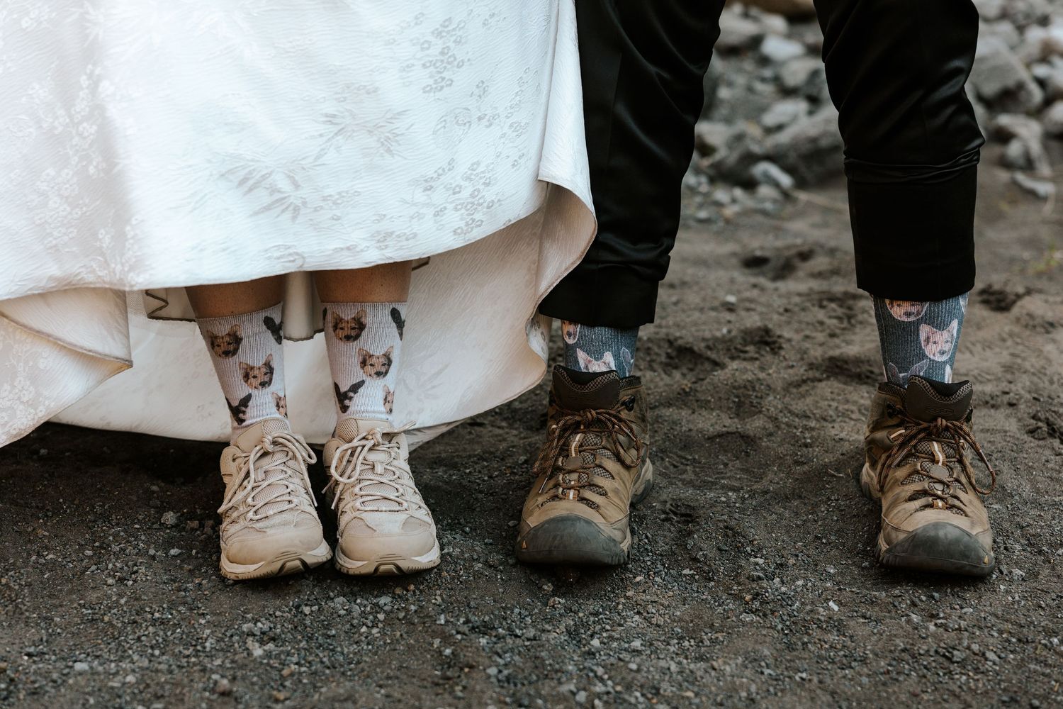 close up detail shot of a couple's bottom half showing off their matching dog socks in their hiking shoes in iceland