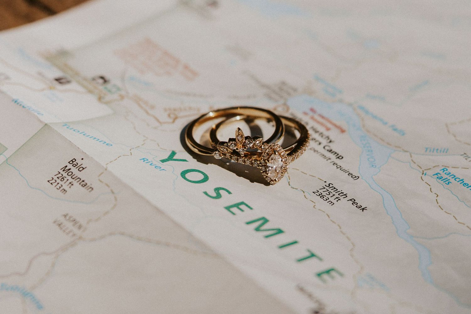 romantic and authentic yosemite national park elopement photographer. detail wedding rings shot on map of yosemite