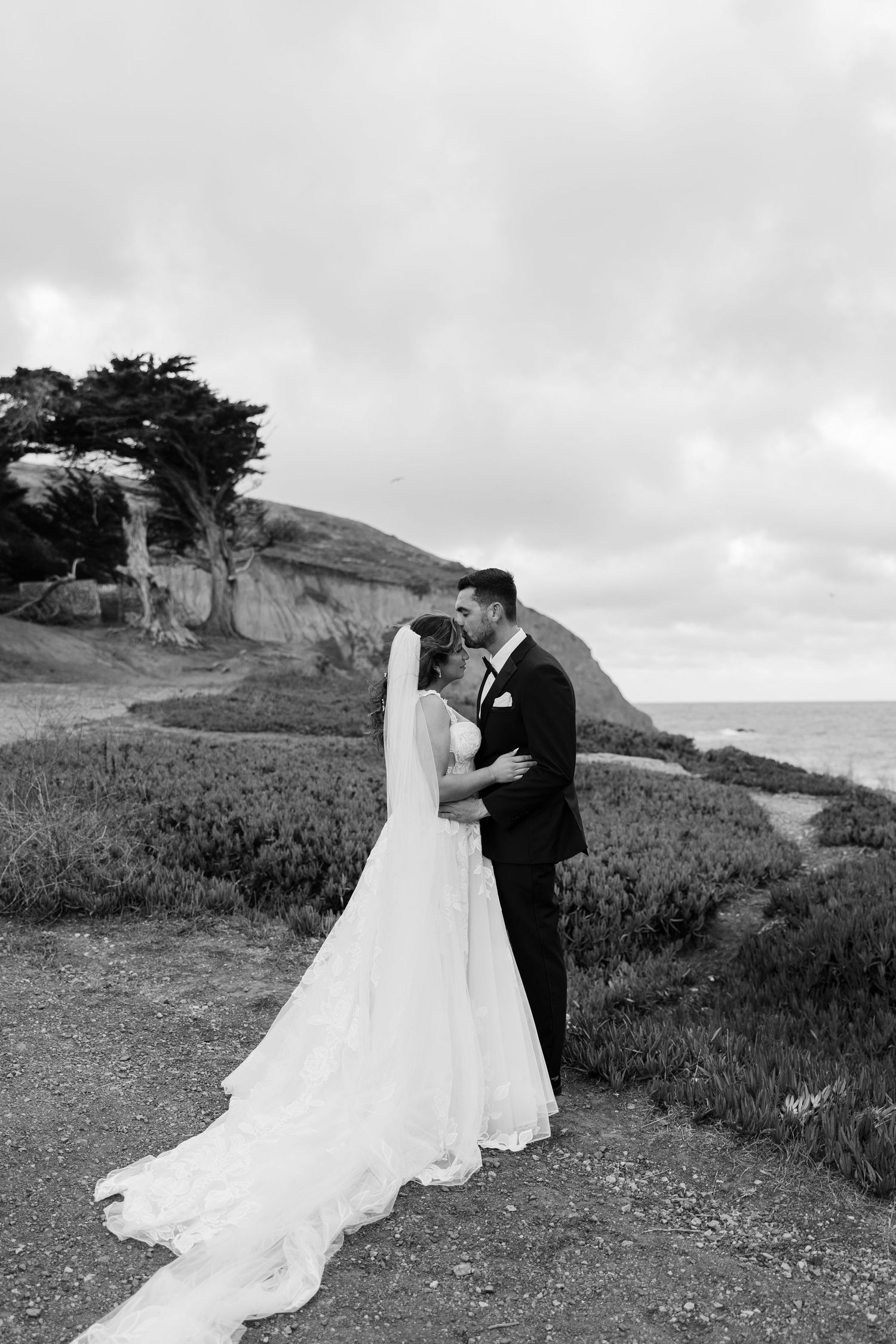 black and white photo of elopement couple kissing on cliffs during bay area elopement day