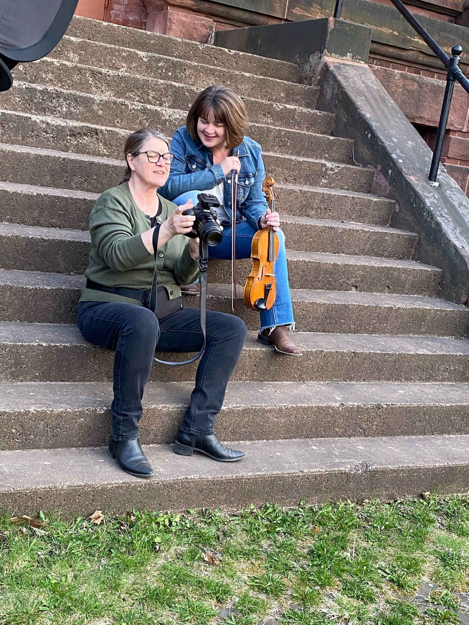 Photographer shows client images on the back of her camera.