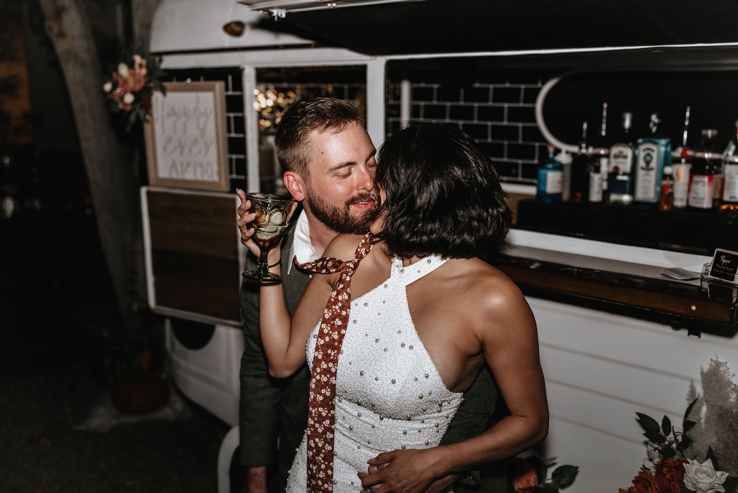 Couple sharing a kiss at their reception