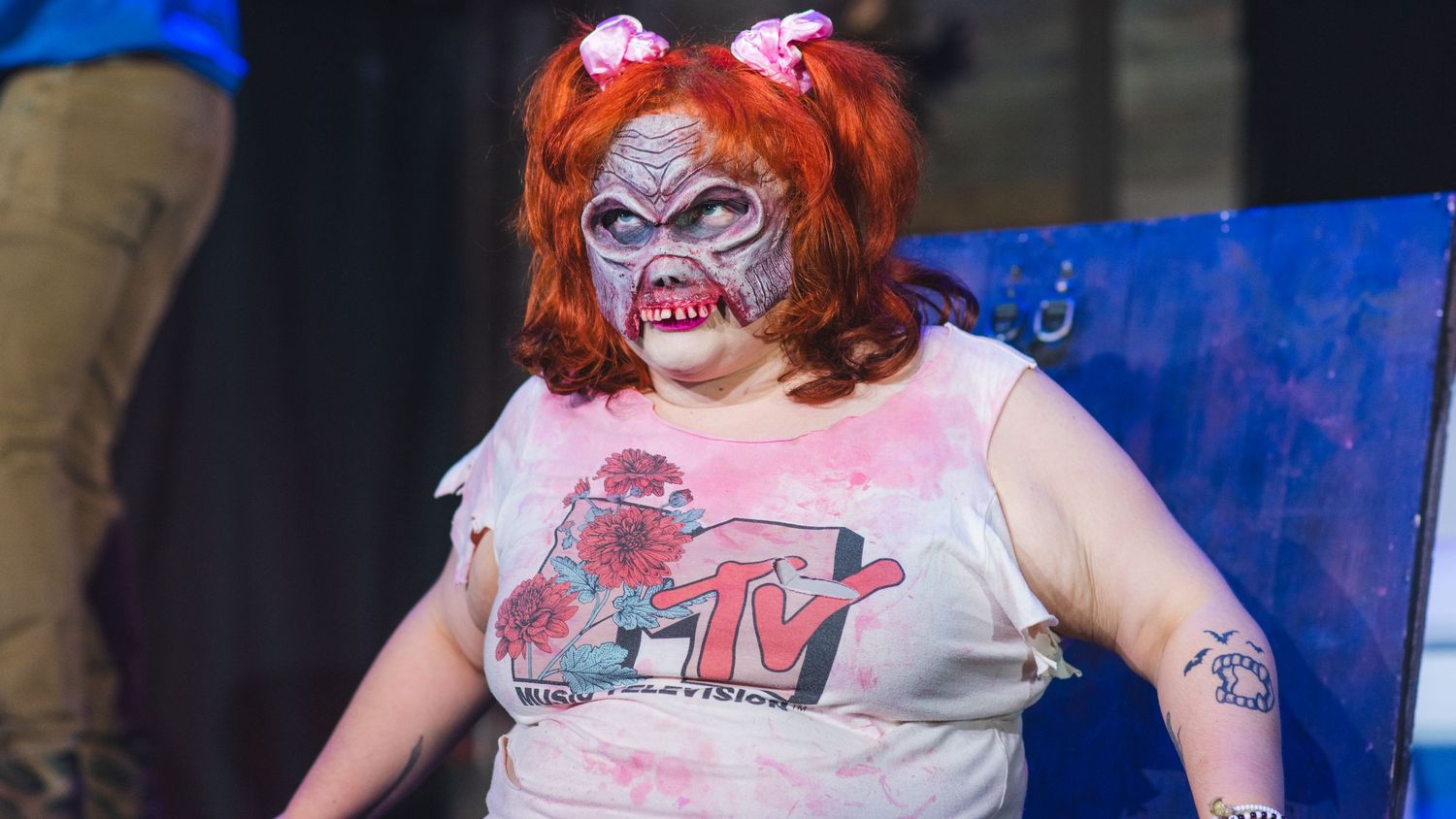 A photo from a production of Evil Dead the Musical. The actress playing Cheryl is featured (as a demon).