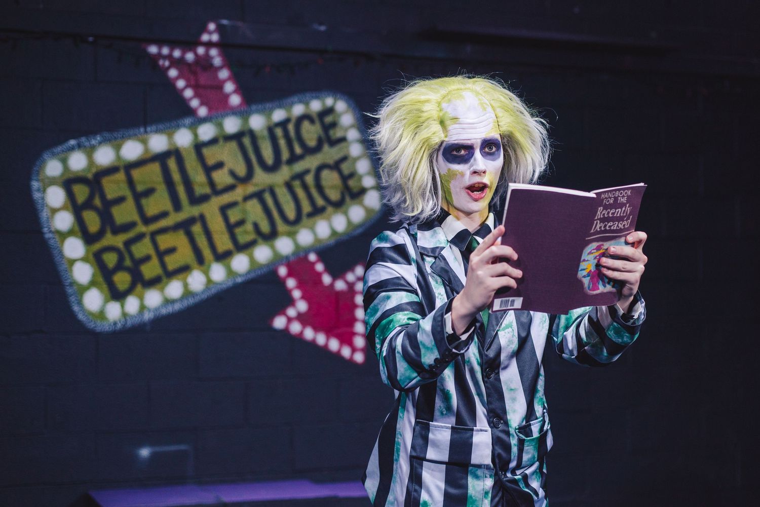 A photo from a production of Beetlejuice. The actor playing Beetlejuice is featured.